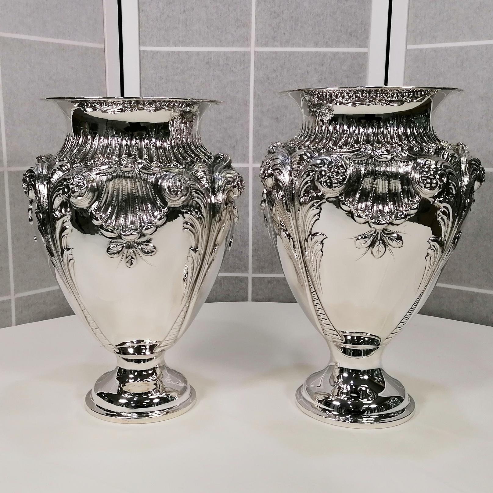 Large baroque style sterling silver vases.
This pair of vases was made by the same master silversmith.
Being made entirely by hand, the vases are similar but not identical, both in size and in the chisel and embossed workmanship.
Suitable for being