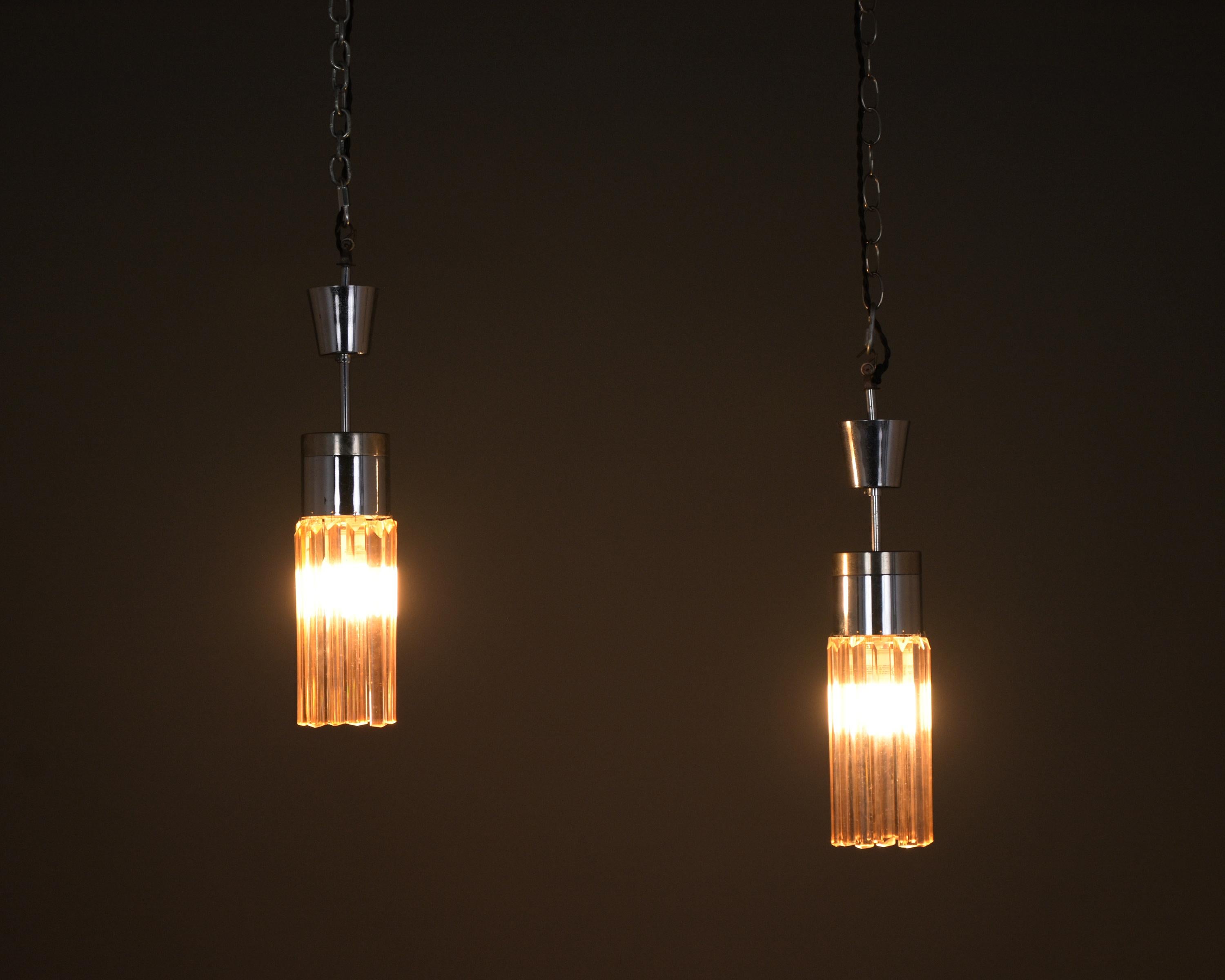 Illuminate your space with our stunning pair of Stilnovo Model No. 1327 Pendant Chandeliers, a rare and extraordinary find for any interior design enthusiast. These chandeliers, beautifully crafted from crystal, are in excellent condition and are a