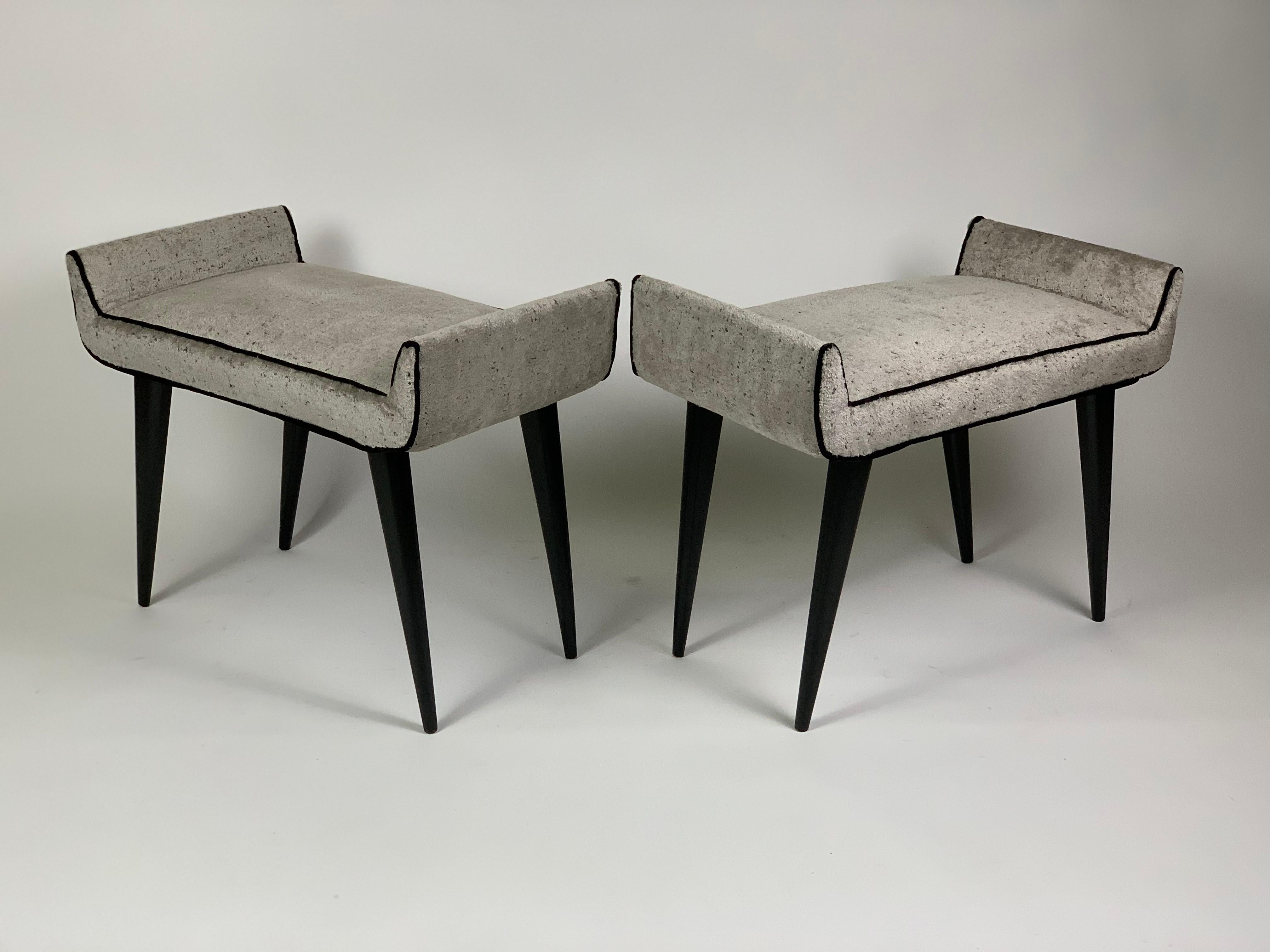 Pair of stuffed stools with four black lacquered wood legs.
Stuffed fabric is new.
The four legs are in wood slightyly spread out and tapered in the bottom.
Both stools are marked with original brand underneath the seat.