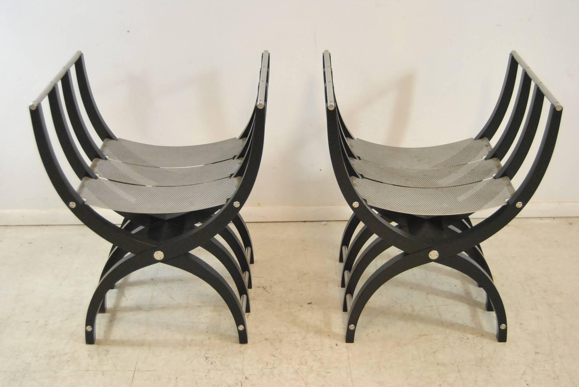 An incredible pair of Savonarola chairs. These unusual chairs feature a black lacquer finish with a pierced steel frame. These unique chairs will make a statement in any home. Very good condition. Dimensions: 20