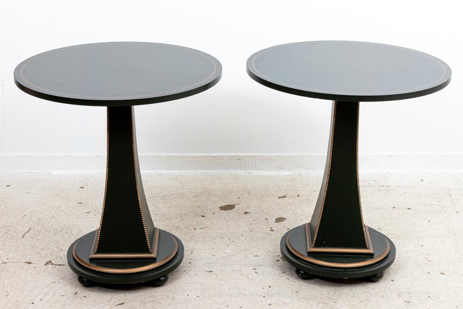 Pair of Italian style pedestal tables in dark olive green color with 
gold painted accent detail and beaded edge square trim. The tables are 
supported by tapered columns mounted on circular plinth bases.
