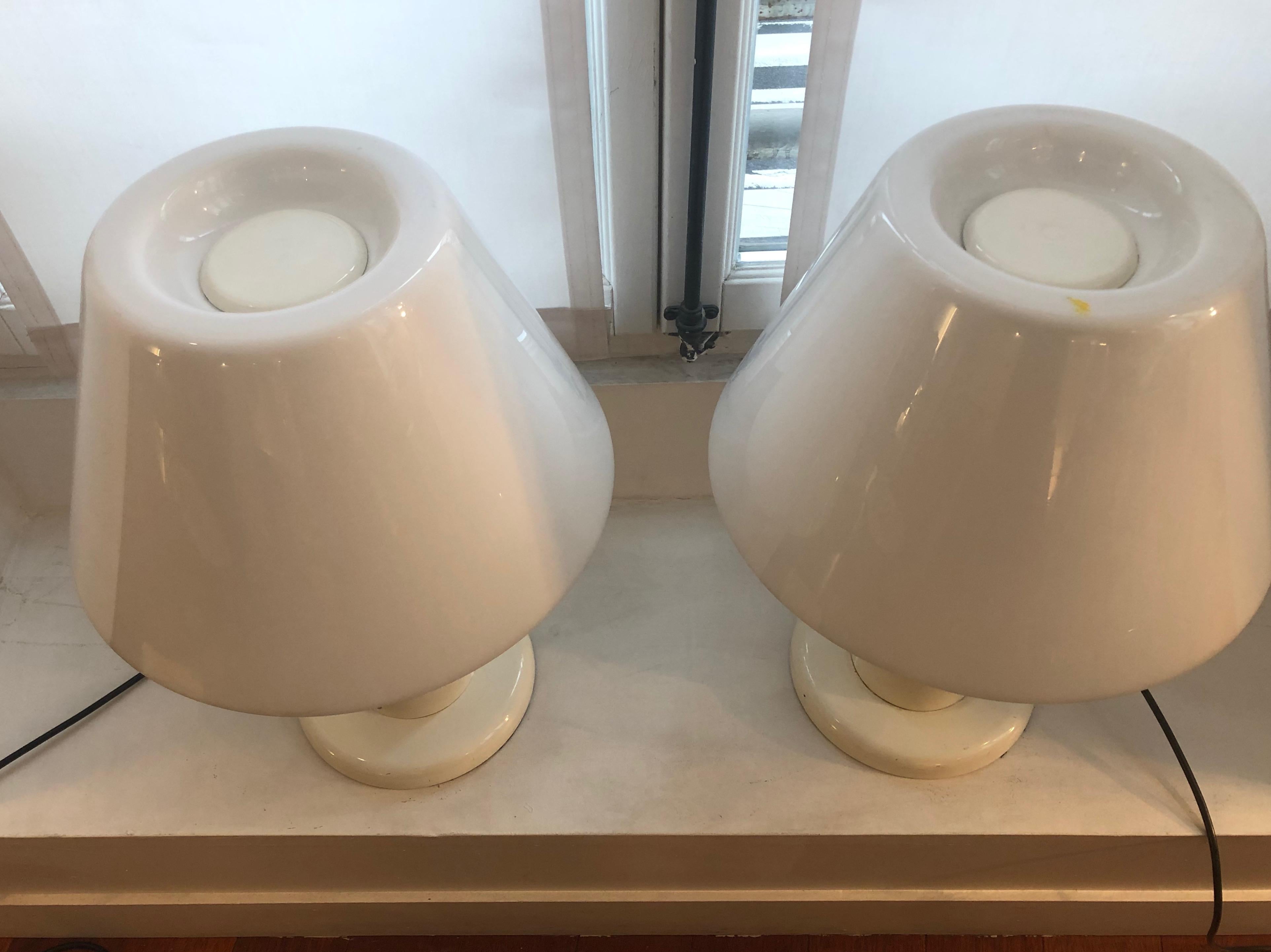 Pair of Italian table lamps by I. Guzzini, circa 1960.
White plexiglass and metal base.

Good vintage condition (one little yellow spot on a table lamp, see picture).

 