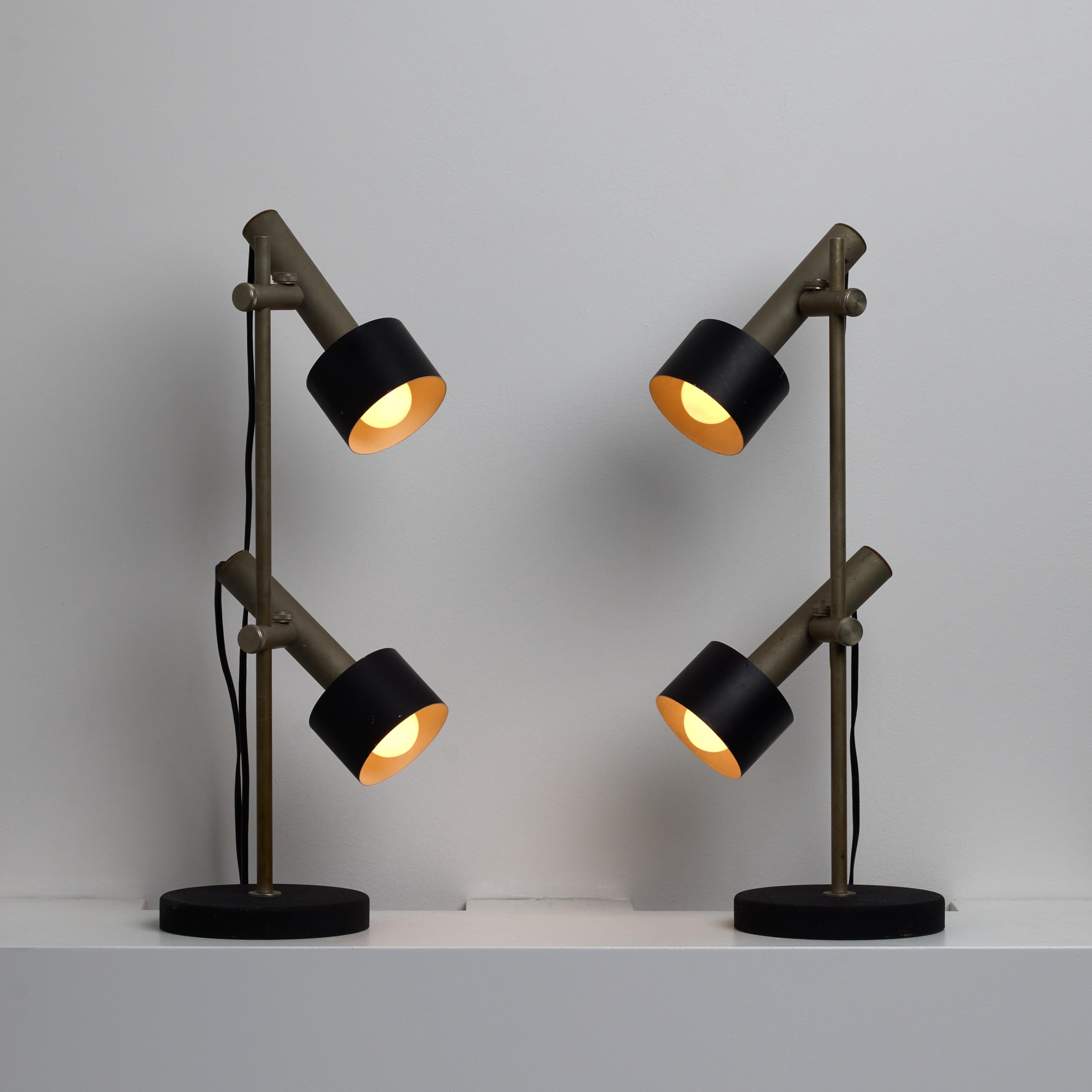 Pair of Italian Table Lamps. Designed and manufactured in Italy circa the 1960s. Each table lamp features a double-shaded post with optimal articulation for both shades. The shades are made of aluminum and the larger drum, is enameled in black. This