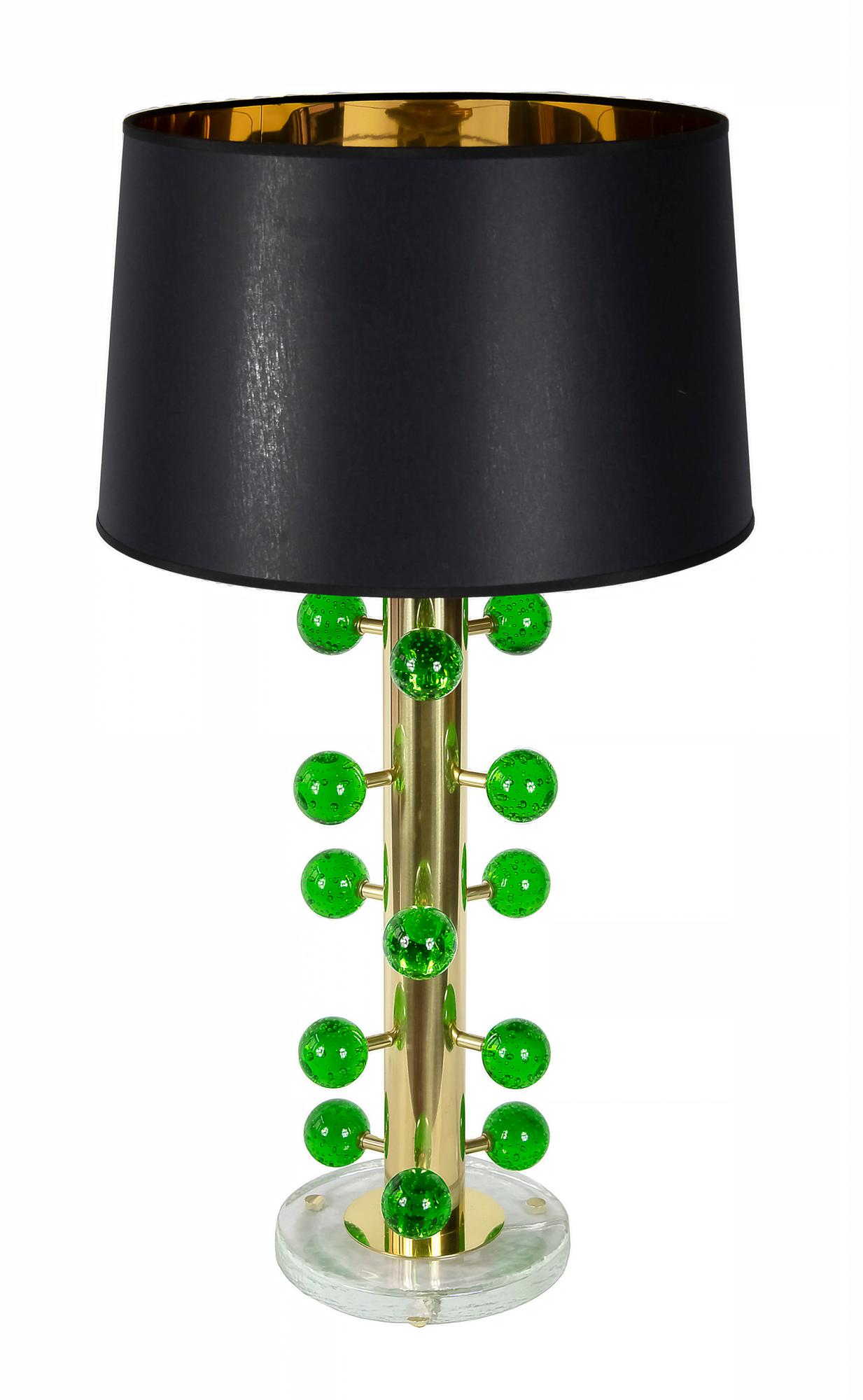 This pair of Italian table lamps are made of solid brass and glass base.
Decorated with green colour Murano glass details.
Both lamps are with new made satin finish black colour textile shade with gold inside.
 