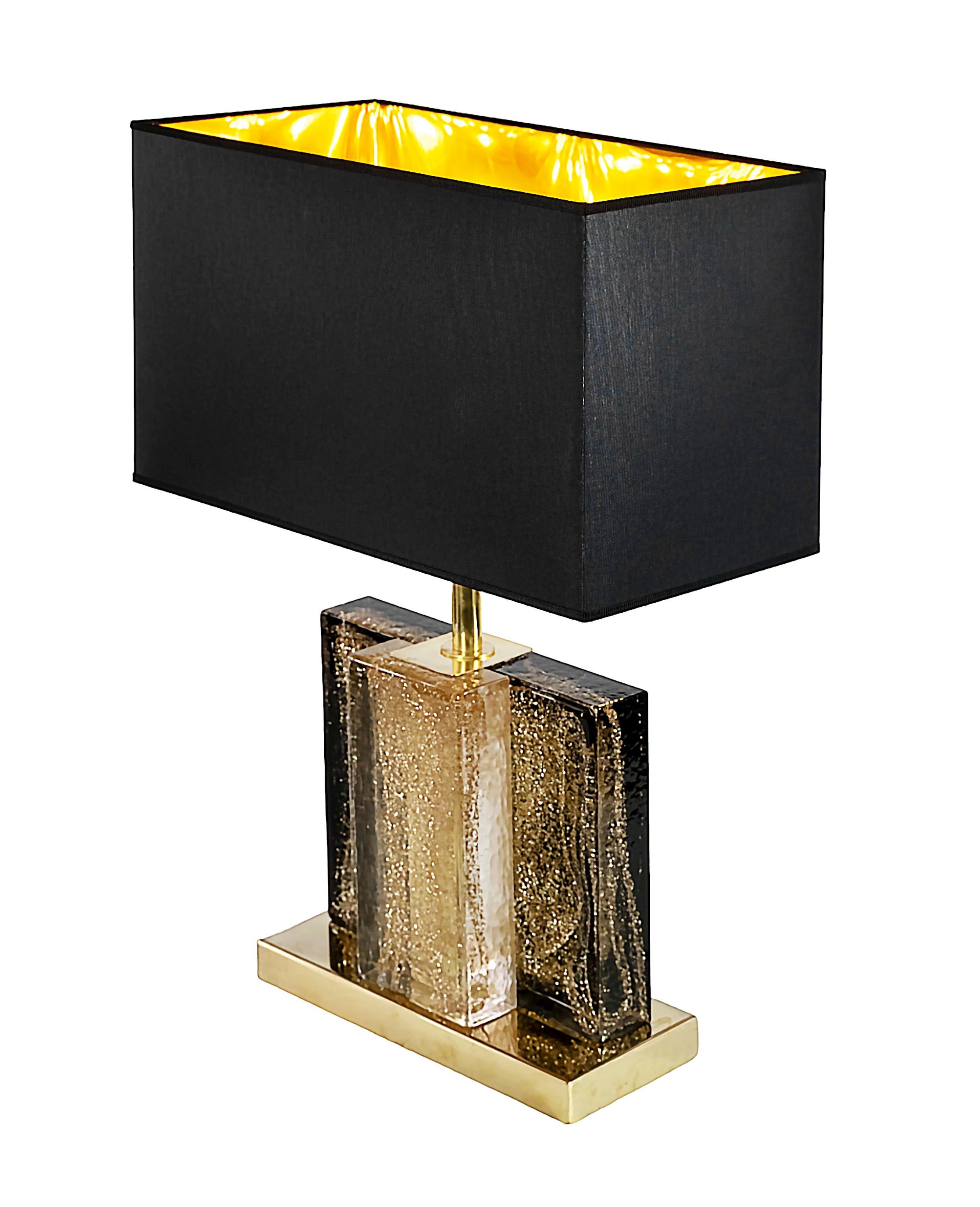 Pair of Italian table lamps.
The base is made in brass. The glass part is handmade Murano glass with inside gold dust.
Both lamps are with new made satin finish black color textile shades with gold inside.
Bulbs E27.

