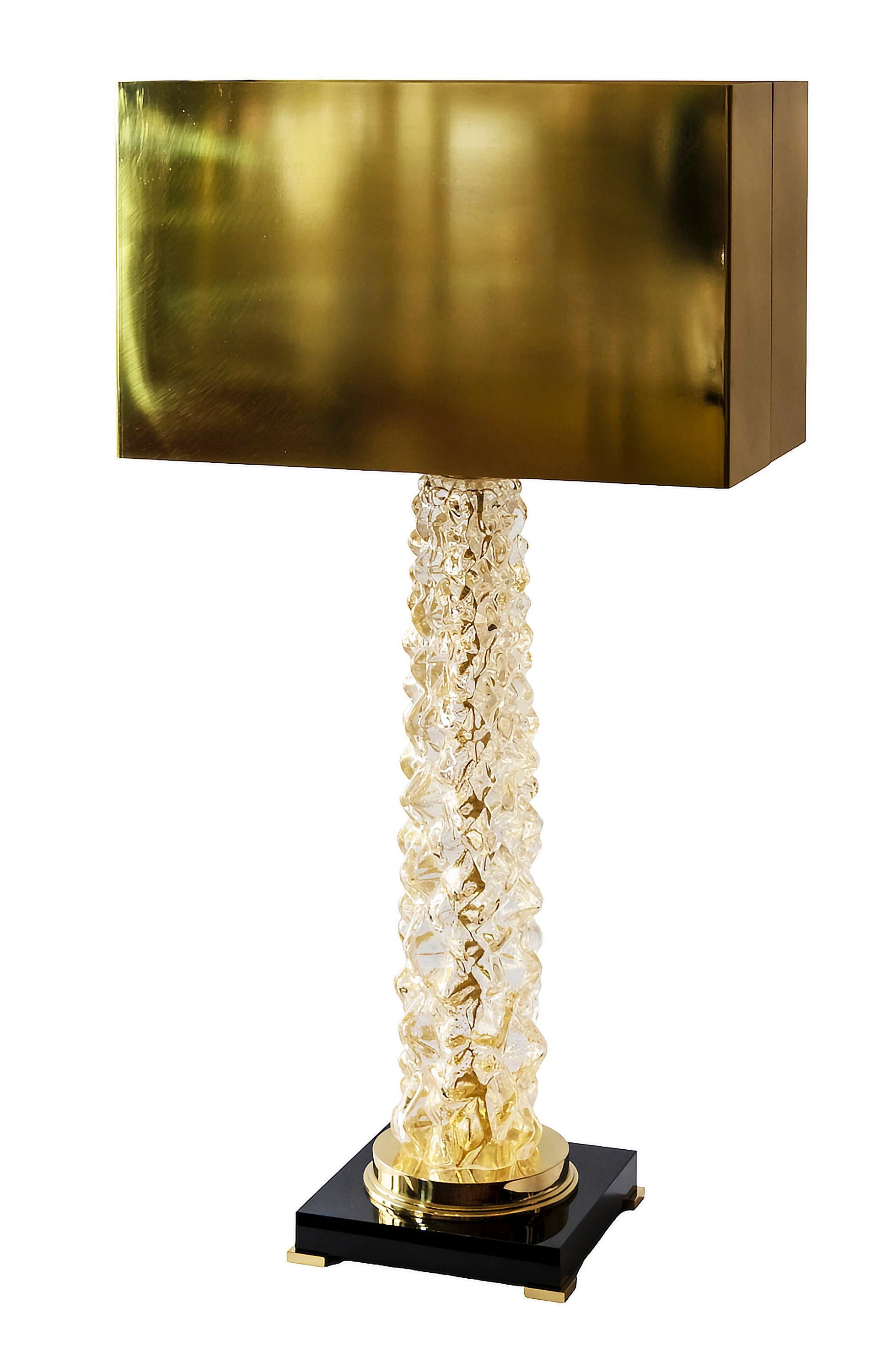 Pair of Italian table lamps are made of transparent Murano glass. The base is made of rectangular thick black glass with small brass legs. Decorated with polished brass details. Both lamps are with new made solid brass shades.
Dimensions: High 85