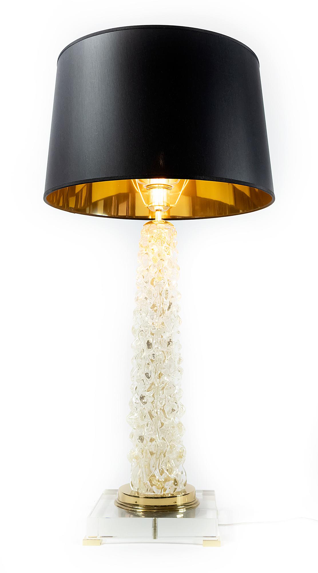 This pair of Italian table lamps are made of transparent Murano glass. The base is made of rectangular thick clear glass with small brass legs. Decorated with polished brass details. Both lamps are with new made satin finish black color textile