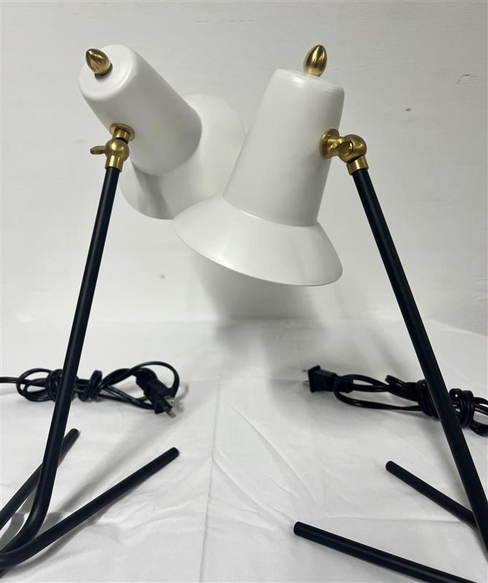 A pair of beautiful Italian Table Lamps by G.C.M.E with enameled black painted base and white cones with brass details. 
New old inventory

Wired for U.S. use.


