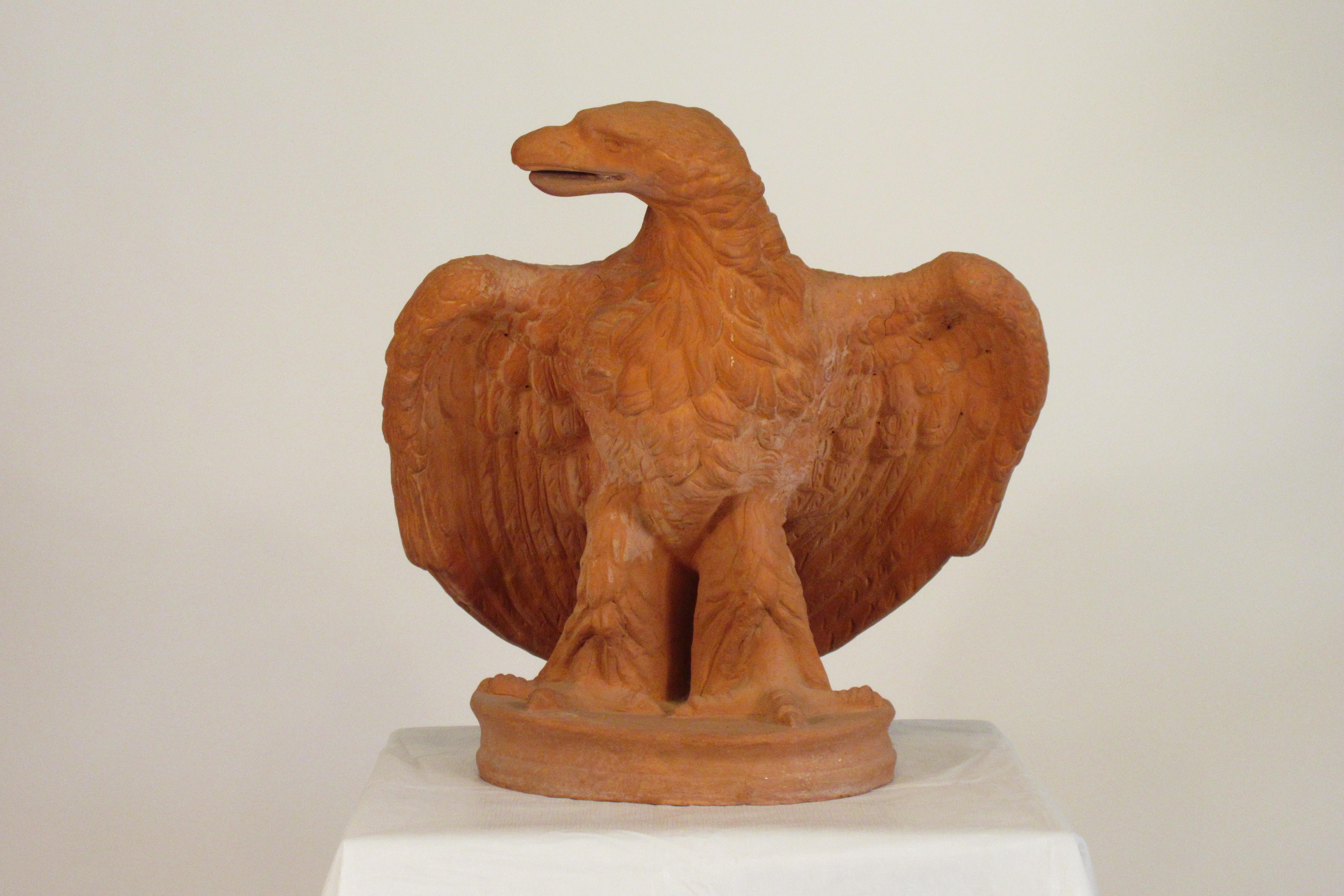 Pair of Italian terra cotta life-size eagles stamped Italy, from the 1970s.