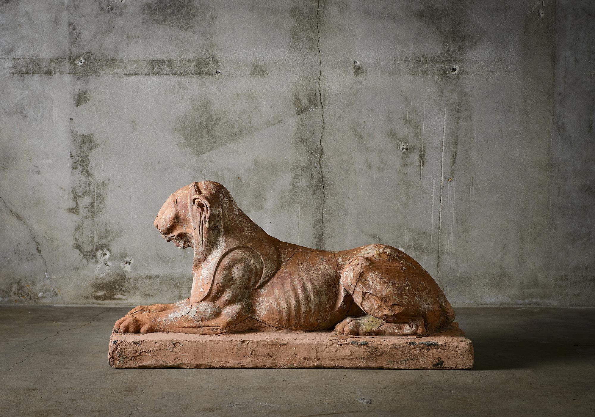 Italian pair of terracotta recumbent lions, early 19th century, Florence.