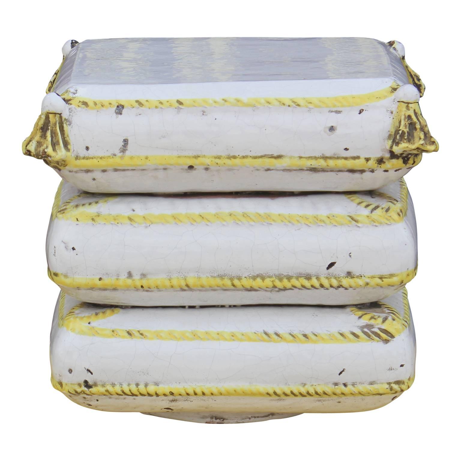 Unique pair of Italian ceramic garden stools in the form of three stacked square cushions with yellow trim and tassels. Perfect addition to any garden in need of something unique. 