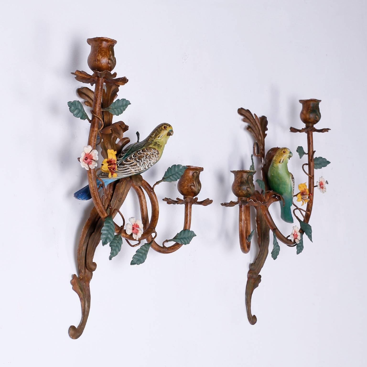 Rare pair of vintage Italian tole sconces with a leaf and flower motif
supporting two candle holders on each sconce. Featuring perched
polychrome parakeets with a curious expression naturally oxidized to perfection.