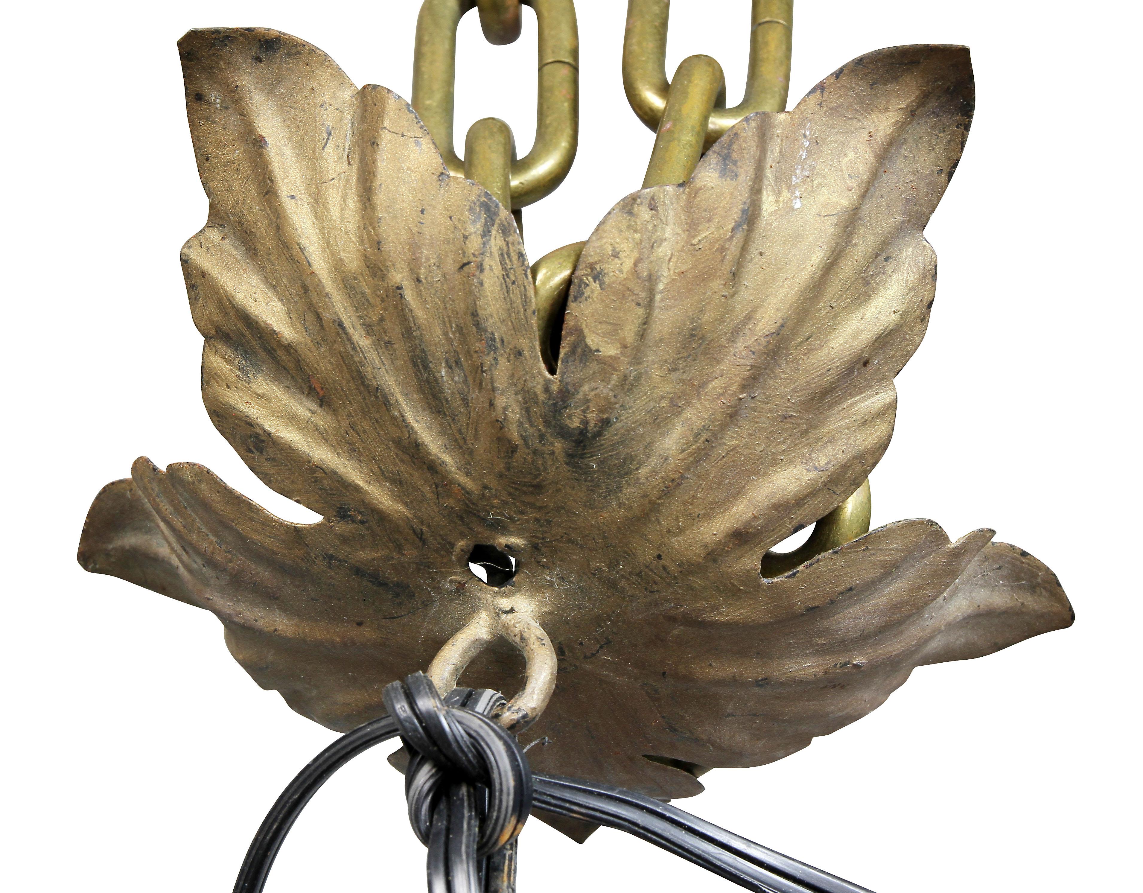 Brought back from Italy by a local woman that had a home there. Electrified. Leaf decoration and iron loop handle with applied leaves.
