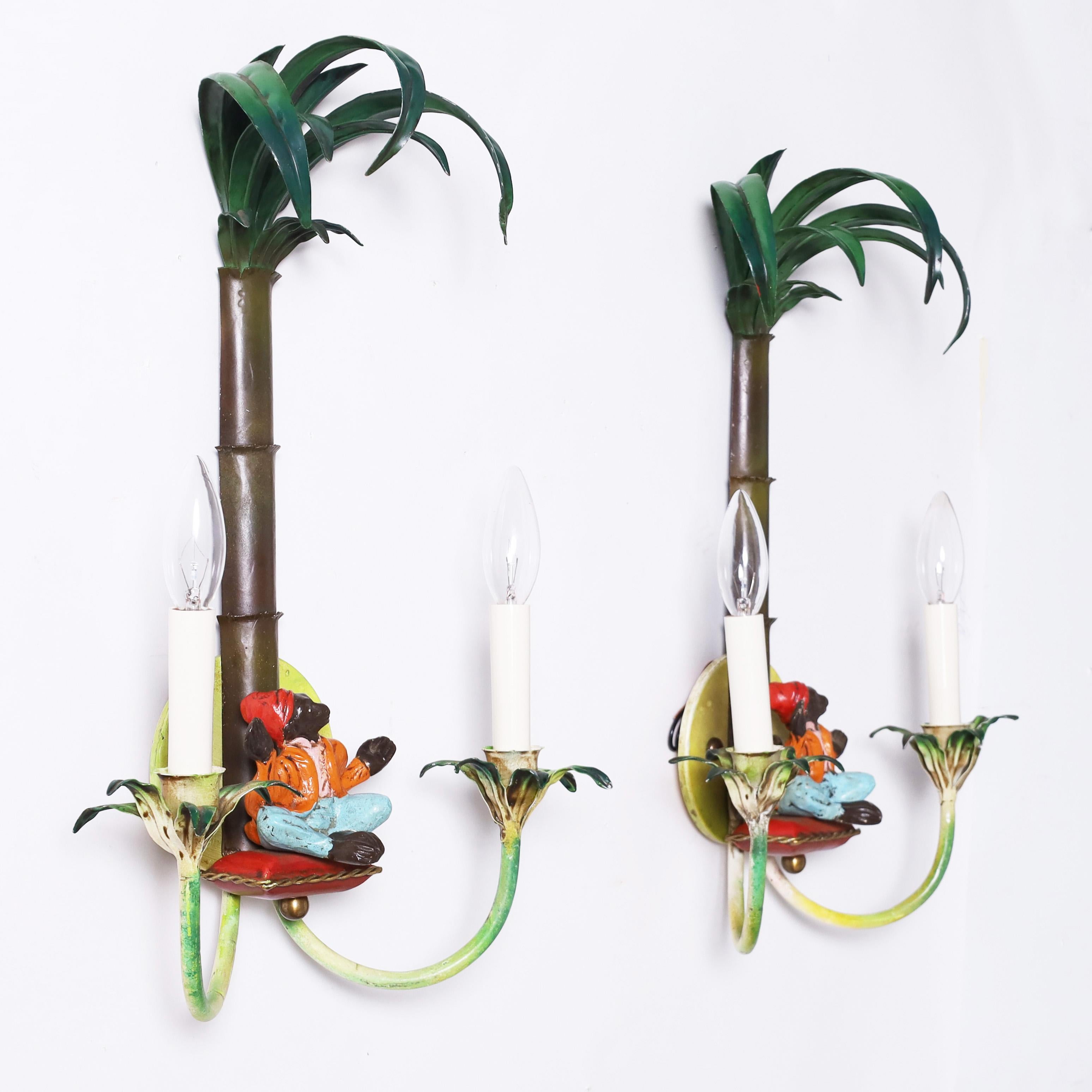 Whimsical pair of vintage Italian wall sconces with palm trees over Moroccan monkeys sitting on a pillow between two arms with leaves around the cups.