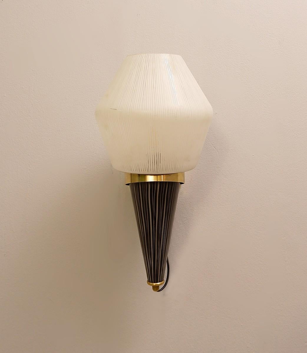 Pair of Italian torch wall sconces in brass and glass.