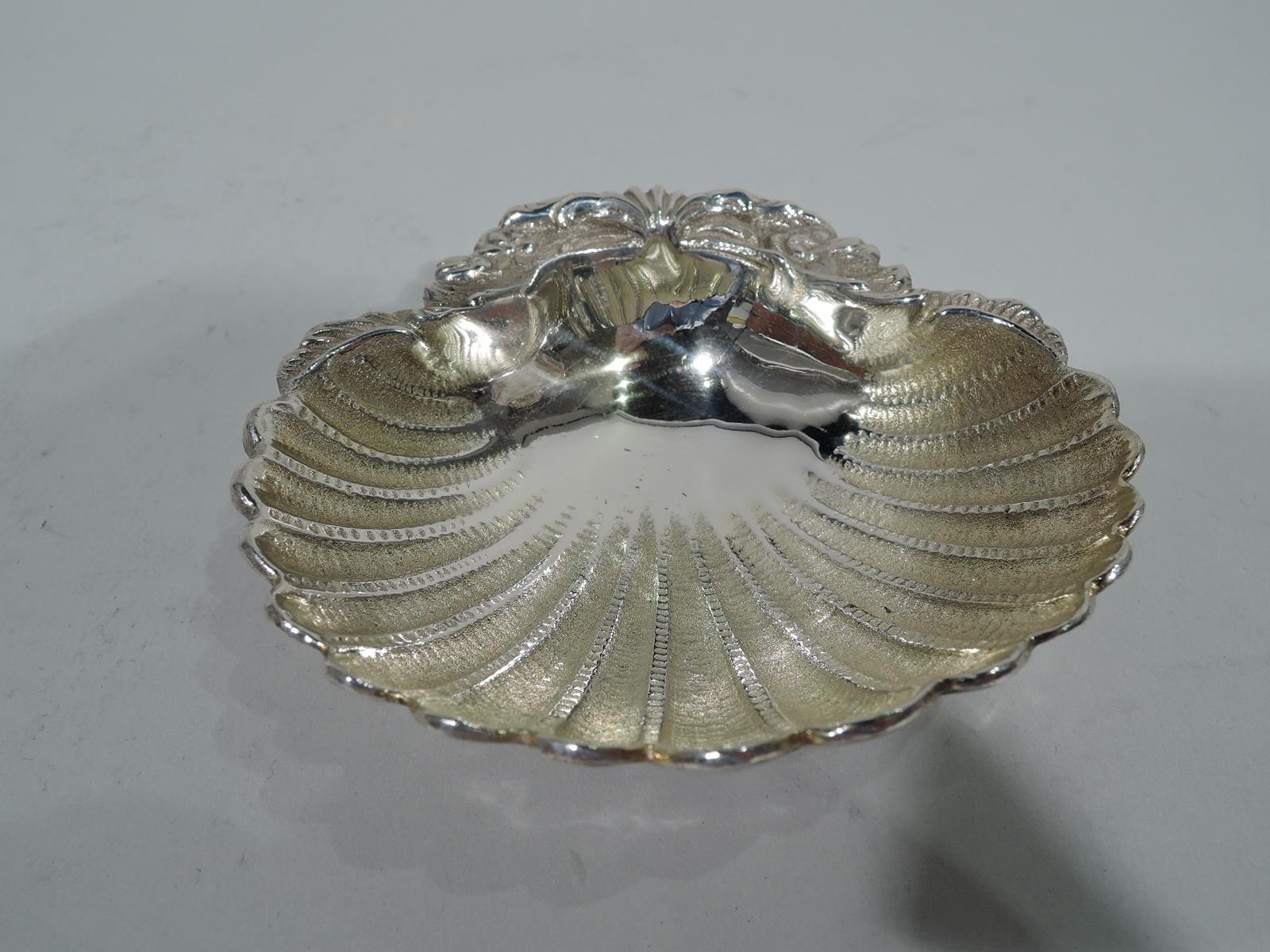 Pair of 800 silver scallop shells. Each: Stippled and pointille flutes and tooled flowers and scrolls. Interior gilt washed. Two ball supports. A traditional form with good heft and texture. Italian hallmark (1944-68). Heavy total weight: 11 troy