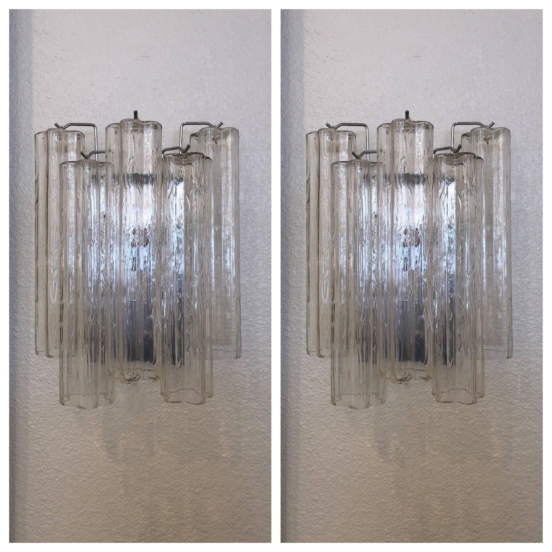 A pair of glamorous Italian “Tronchi” Murano glass and polish chrome wall sconces from the 1970s by Venini. 
Dim: 15” high 12” wide and 7” deep.