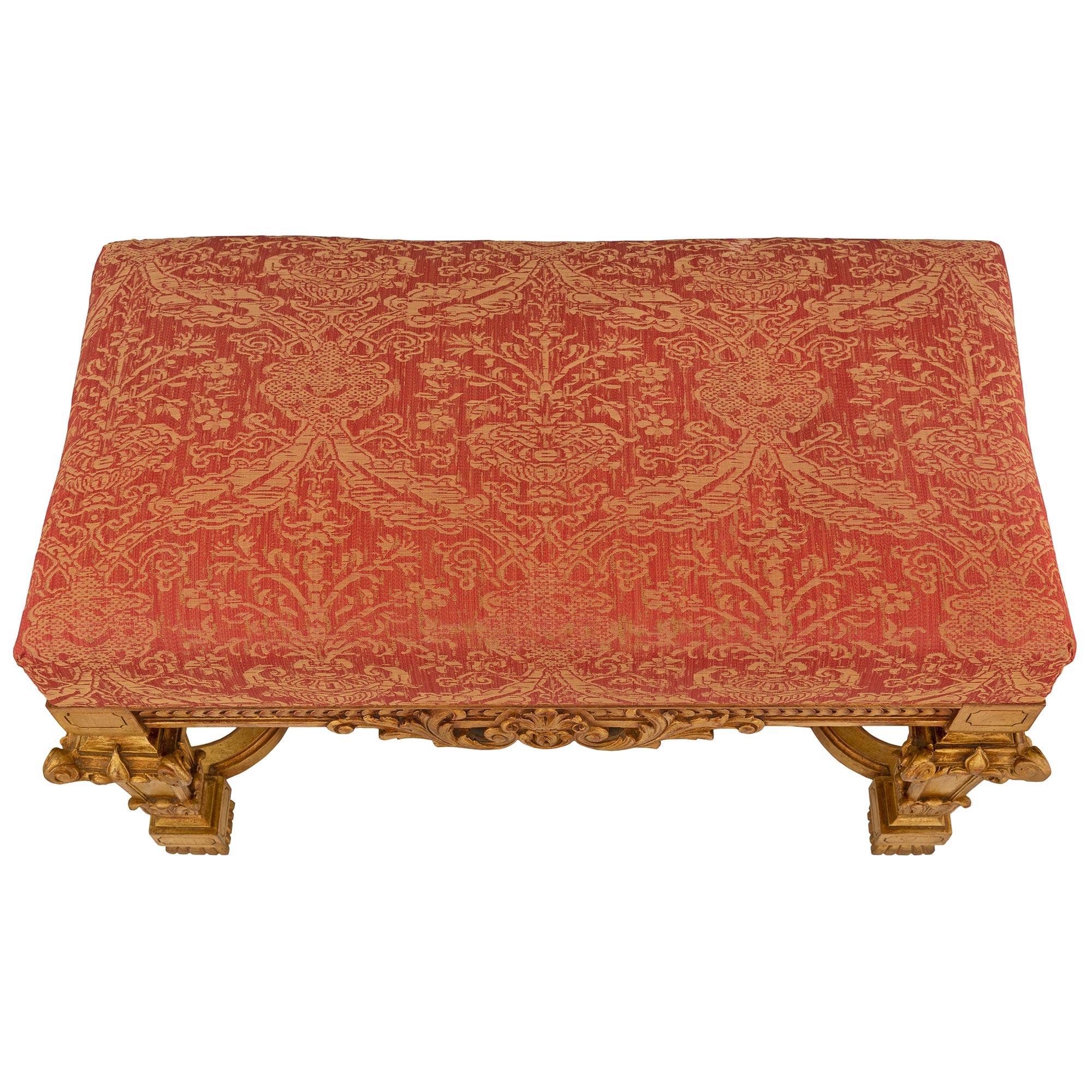 An impressive and most decorative pair of Italian turn-of-the-century Louis XIV st. mecca benches. Each bench is raised by fine reeded gadroon feet below block reserves each connected by a scalloped shape stretcher with an elegant curved design