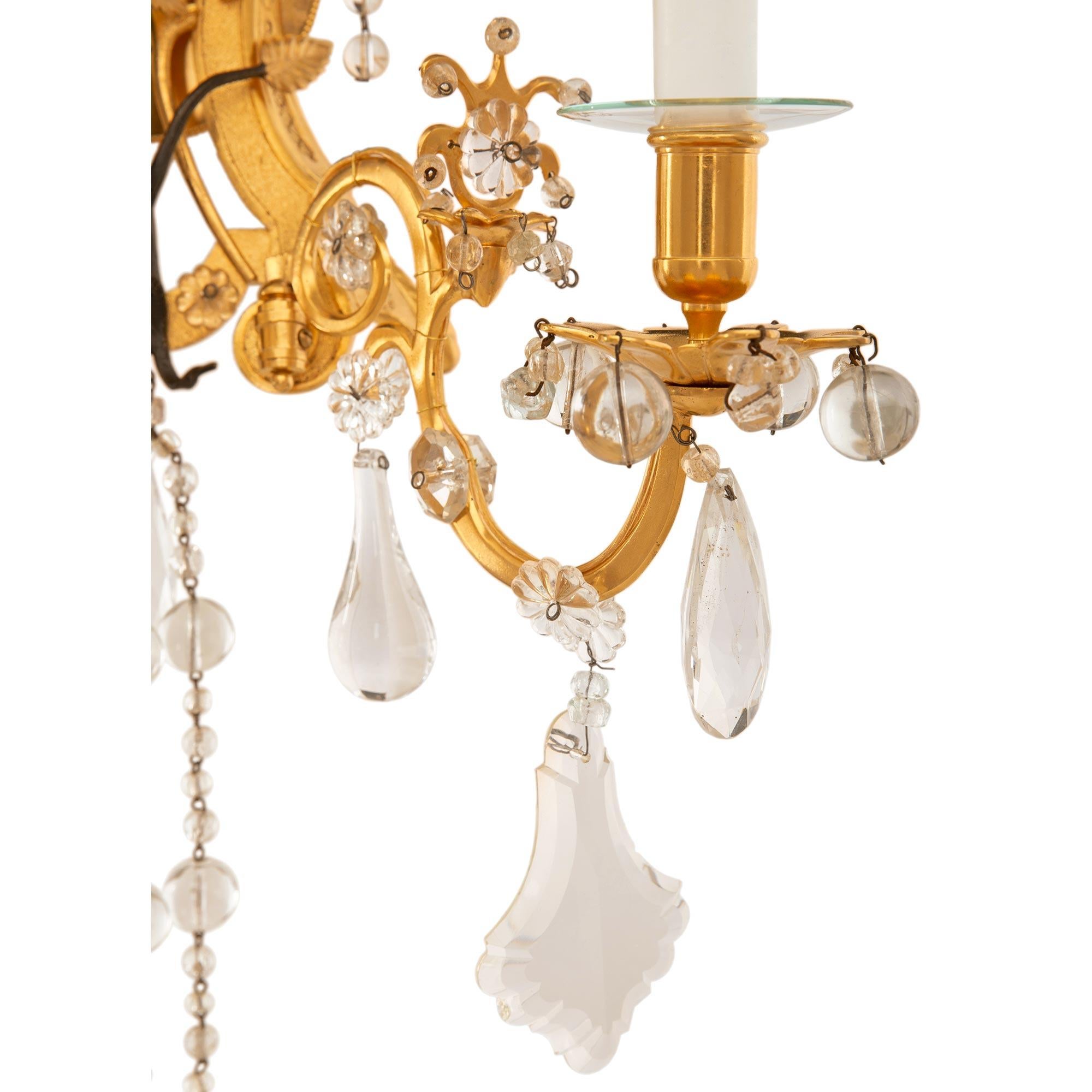 Bronze Pair of Italian Turn of the Century Louis XVI St. Ormolu and Crystal Sconces For Sale