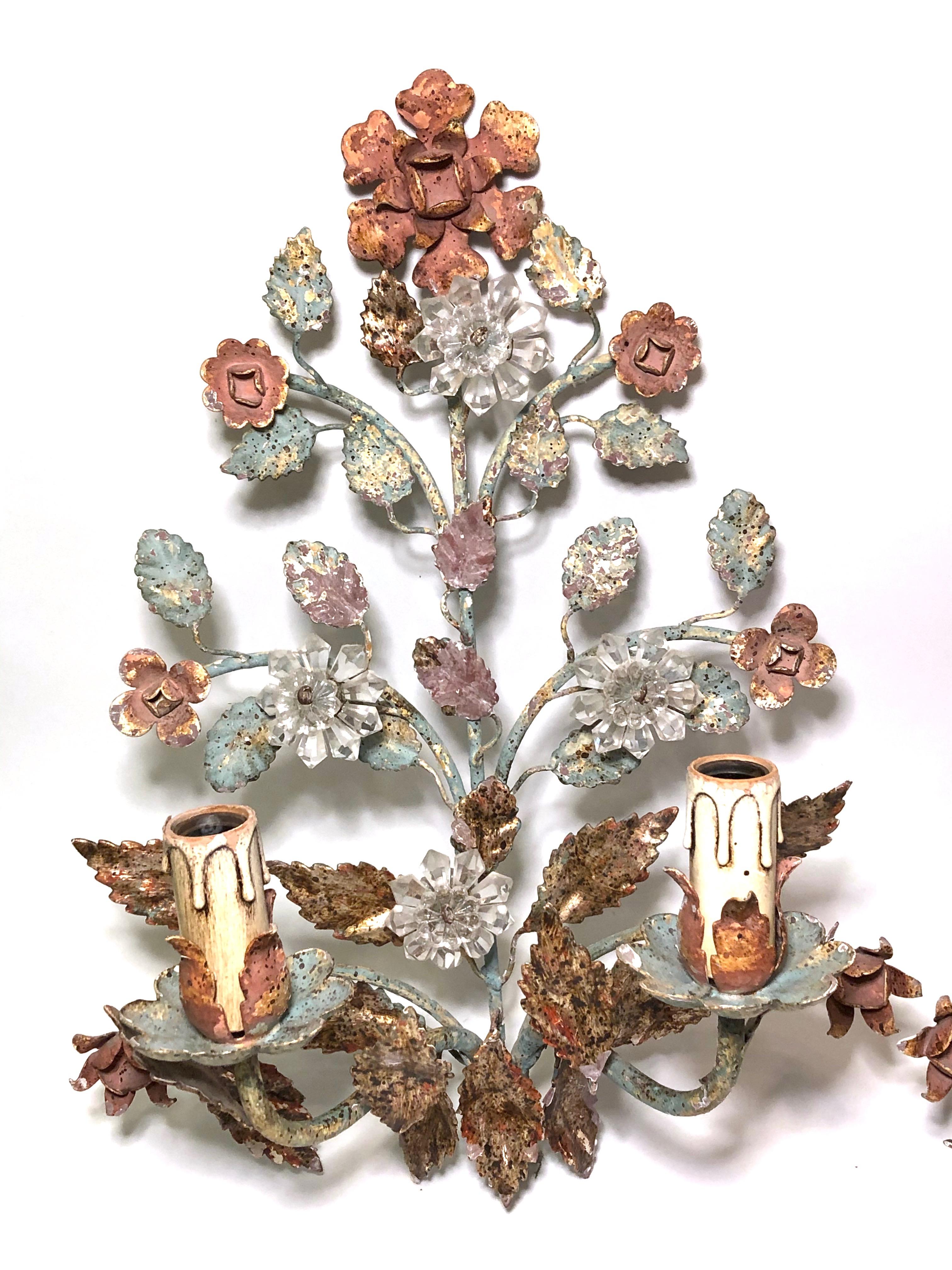 Vintage pair of Italian iron sconces, two polychrome two-light sconces, manufactured by Banci Firenze, decorated with crystal flowers.

Each Fixture requires two European E14 / 110 Volt Candelabra bulbs, each bulb up to 40 watts.
Made in Italy,