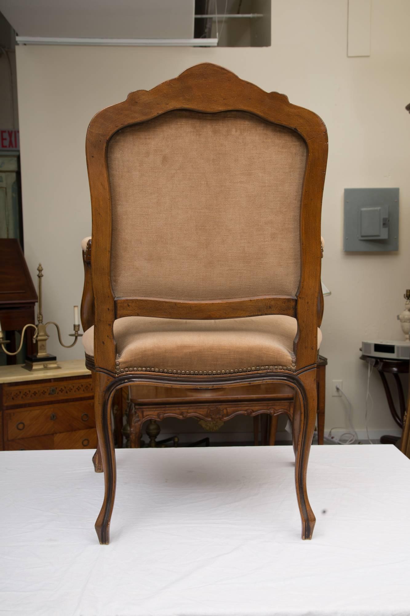 These chairs are hand-carved and upholstered in a soft neutral fabric. Although the chairs are 20th century they are modeled after the design of the period.