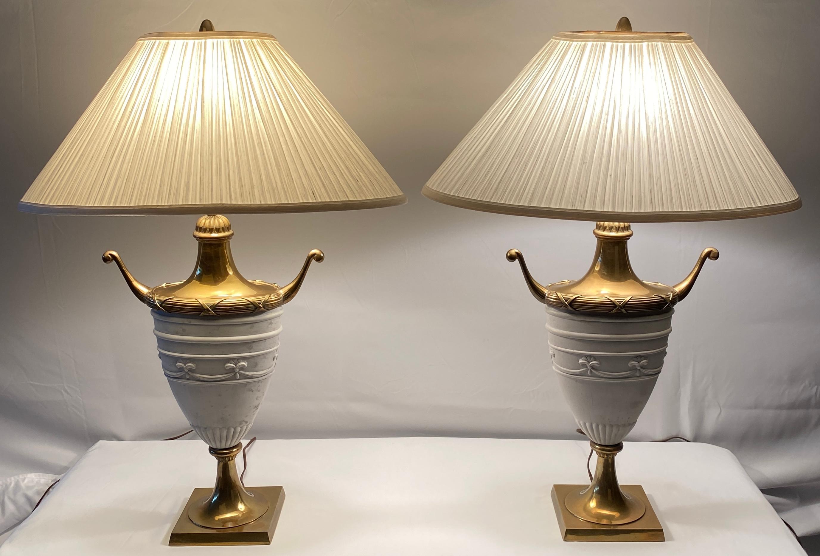 Very decorative pair of white ceramic urn shaped table lamps. These stylish ceramic table lamps would enhance any side tables, night stands, credenza or consoles in a living room, dining area, bedroom or home offer. Made in Italy, wired for use in