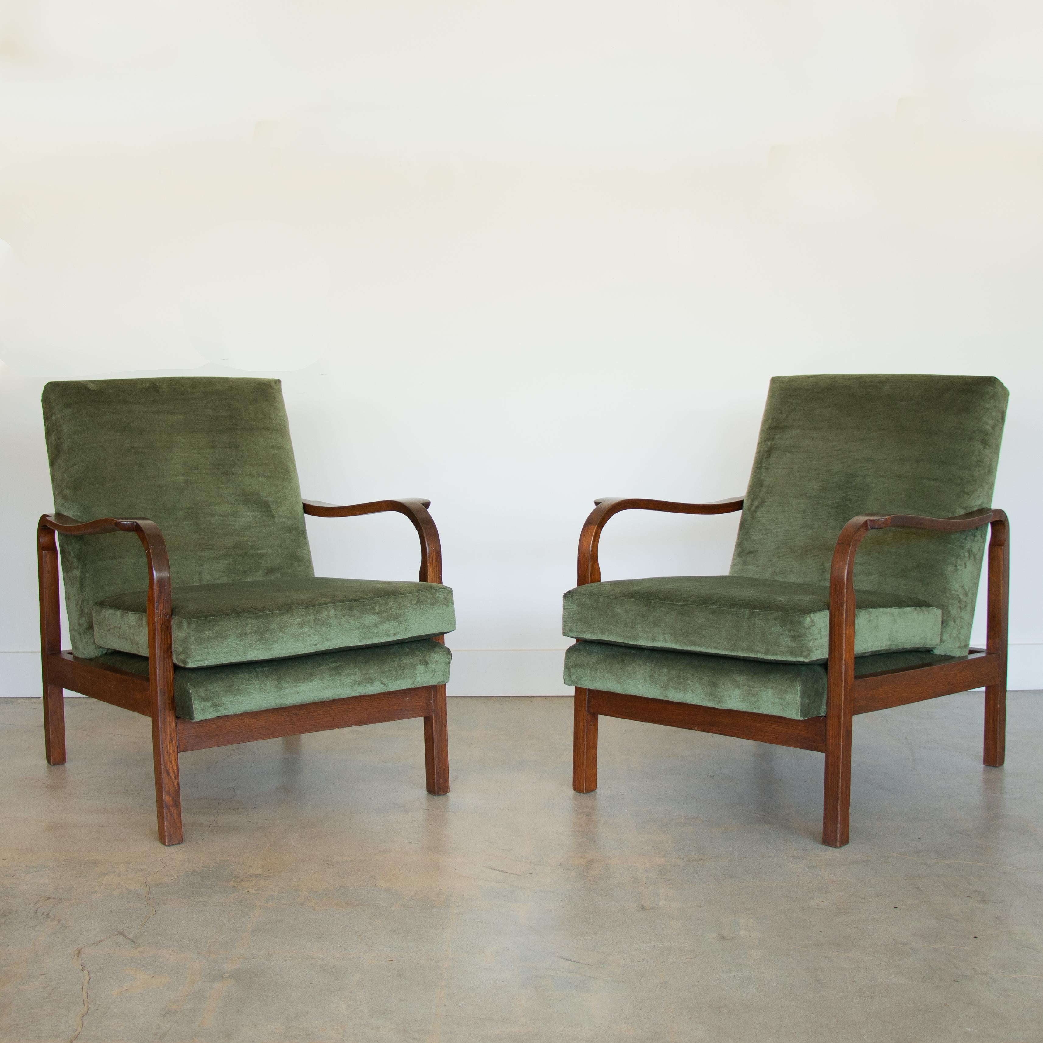 Stunning pair of carved wood armchairs from Italy, 1940's. Beautiful carved wood arms and wood frame with original dark stain showing grain. Original finish shows great age and patina. Newly upholstered seat and back cushions in soft emerald green