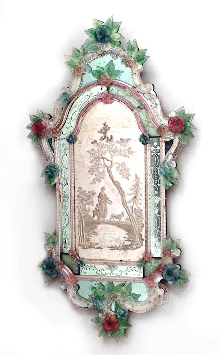 Pair of Italian Venetian Murano (19th century) vertical wall mirrors with etched scene of figures in landscape and trimmed with floral colored glass flowers.
 