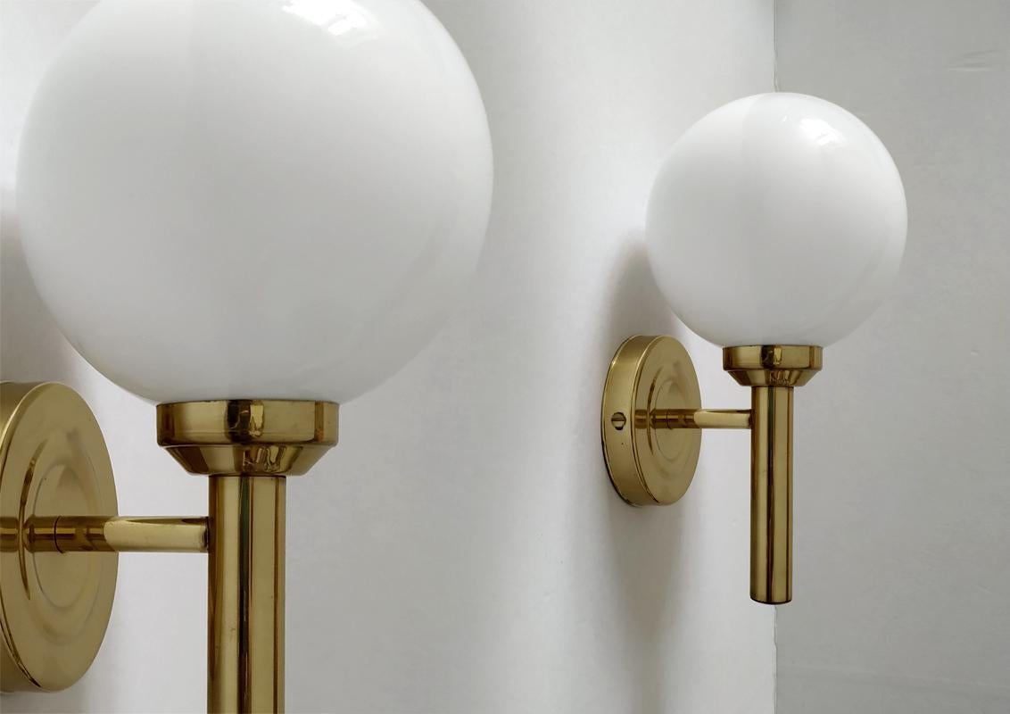 Beautiful architectural pair of modernist brass and hand blown opal white glass wall sconces.
Italy, 1960s
Lamp sockets: 1.
Measures: Base, D 4.4 In (11.2 cm).
