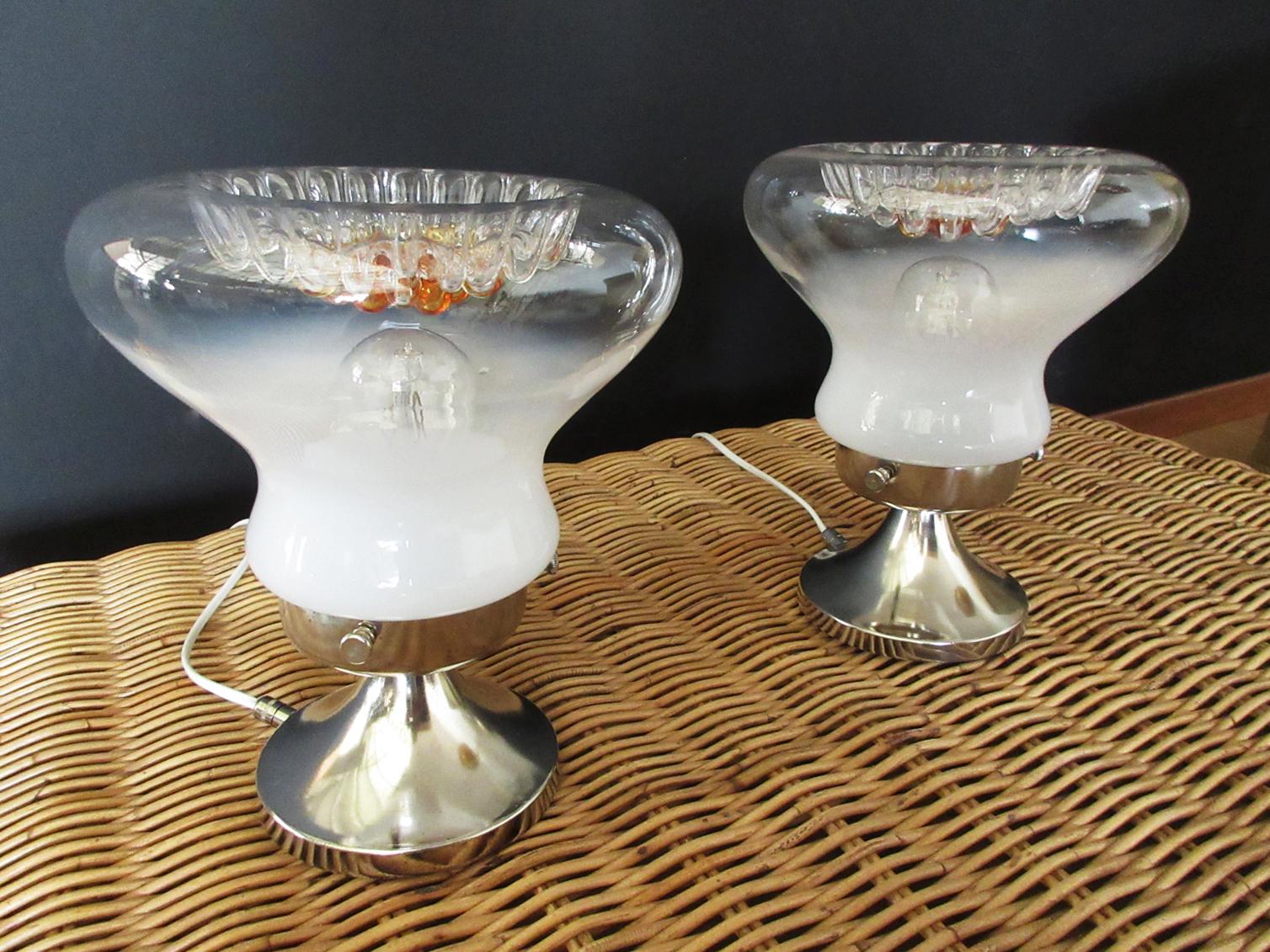Couple of Italian vintage Murano table lamps made by two fantastic glasses, white color at the bottom, transparent and caramel in the upper part, typical colors of the Mazzega glasses. Nickel metal frame. The power cable and the switch has been