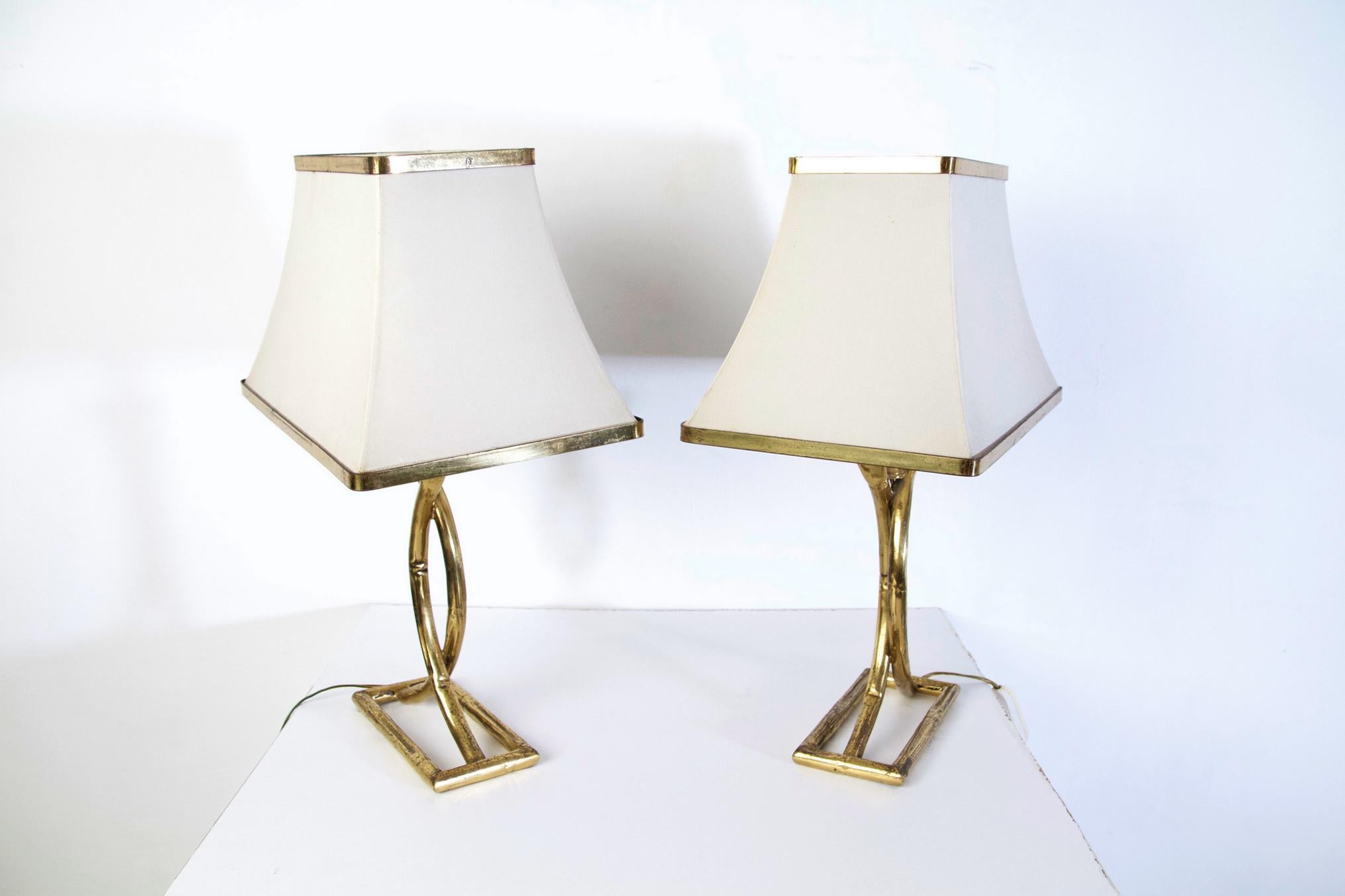 Pair of nice vintage table lamps in brass bamboo imitation with rectangular bases and white pagoda shaped white lampshades. There is patina on the brass which can be polished to shine even more.