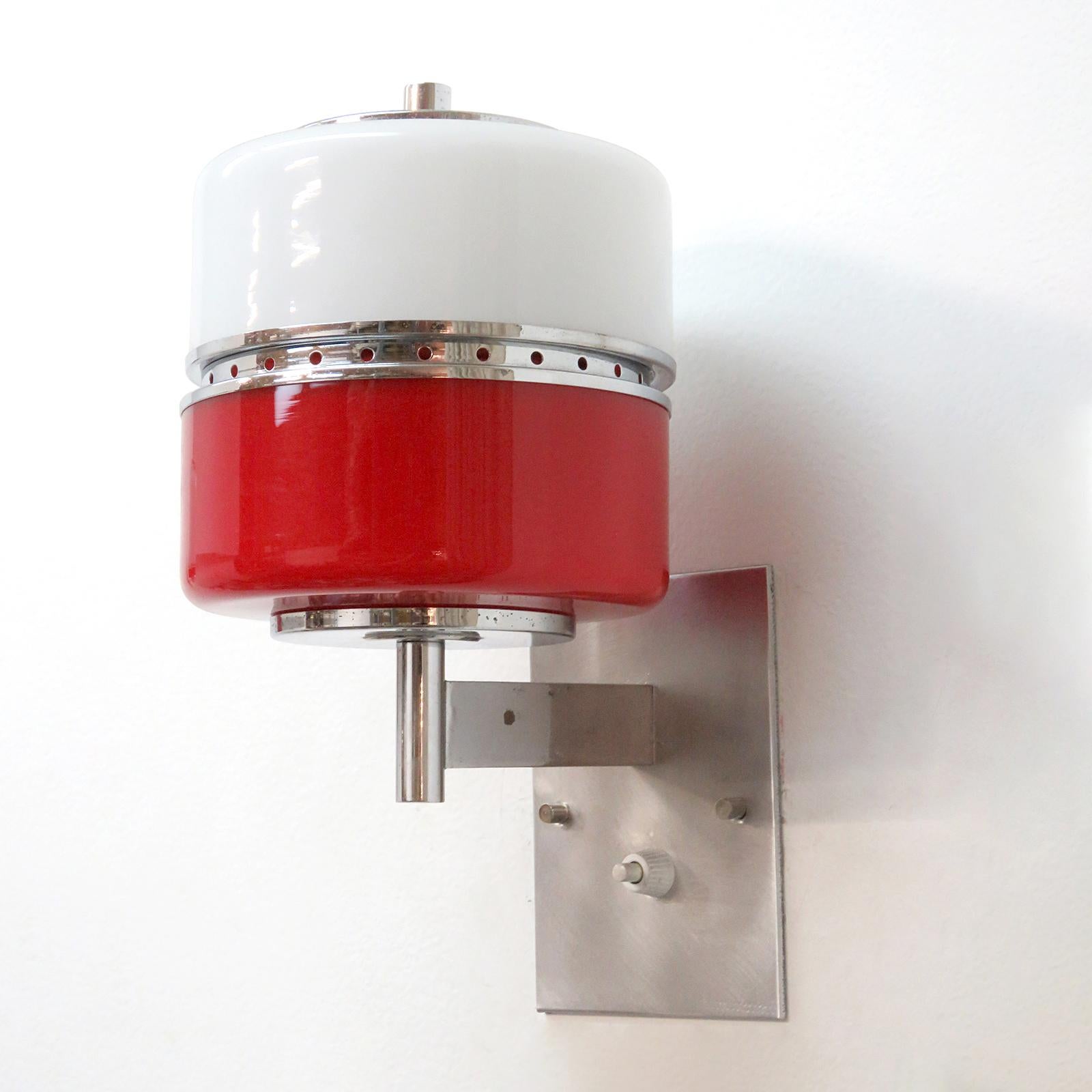 wonderful pair of cylindrical Italian wall lights from 1970 in red and white glass with chrome hardware, wired for US standards with individual on/off switches at each back plate, one E27 socket, max. wattage 75w, bulb provided as a onetime courtesy.