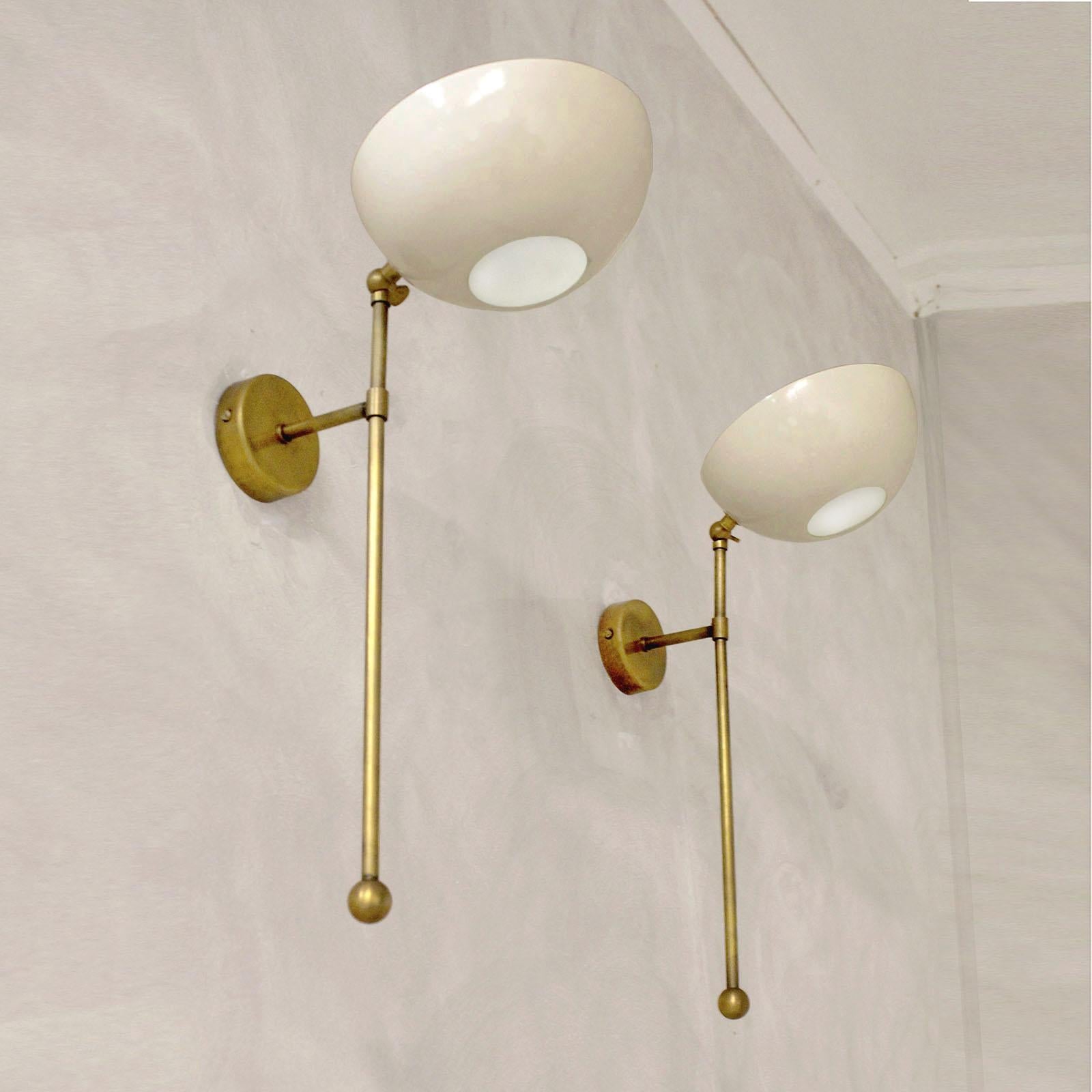 Beautiful pair of wall lights, made of brass and lacquered metal, adjustable shades, painted in ivory.

Customization:
Customizable colors (any RAL code color), available in polished brass, patinated brass, nickel finish. Dimensions slightly