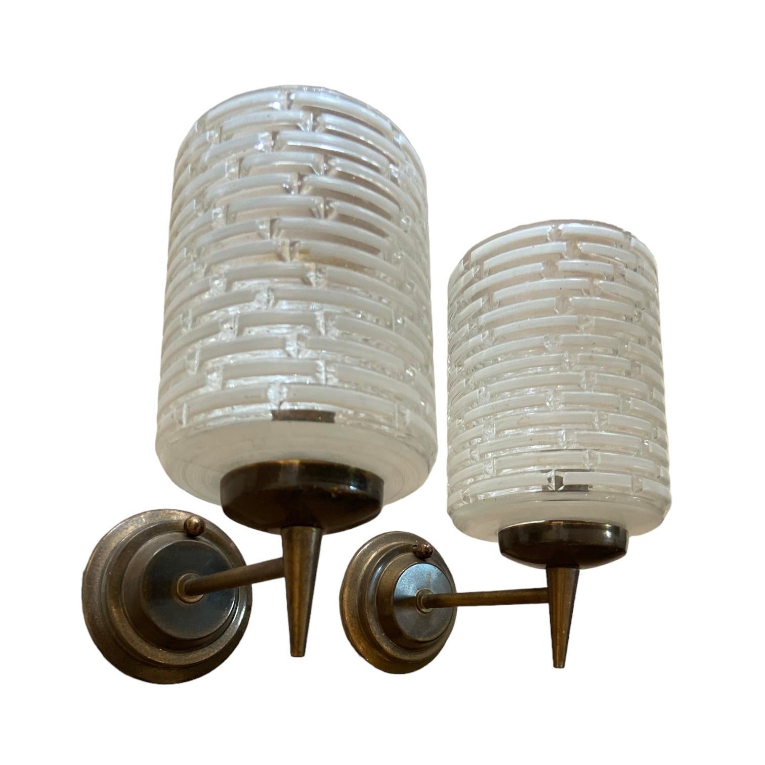 Pair of Italian Wall lights in bronze and glass shades.
Italy, circa 1950. H: 25cm. W: 9cm. D: 13cm.