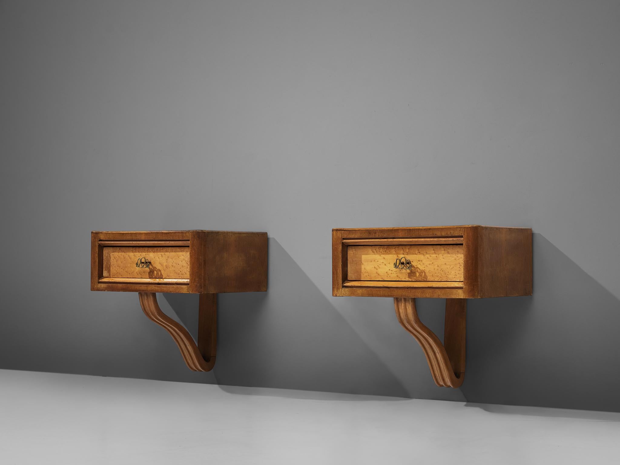 Pair of hanging nightstands, walnut, bird's eye maple, brass, Italy, 1950s

This delicate pair of wall-mounted night stands features one drawers resting on a volute. The front of the drawers is highlighted with a bright veneer and accentuated with