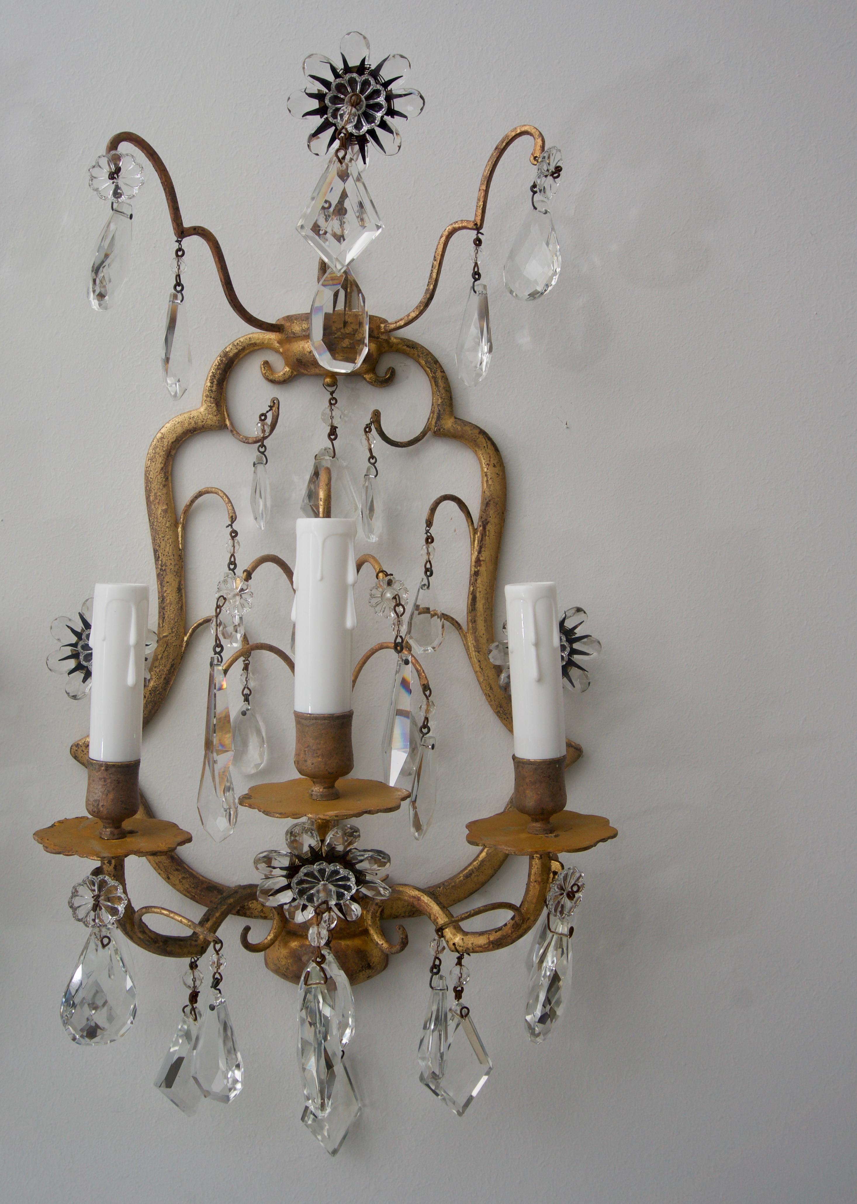 This stylish pair of wall sconces were acquired in Florence, Italy and date to the 1960s-1970s. The frame has a antiqued gold finish with sparkling, faceted crystals and the flowers have a wonderful detail of a black metal sunburst form that