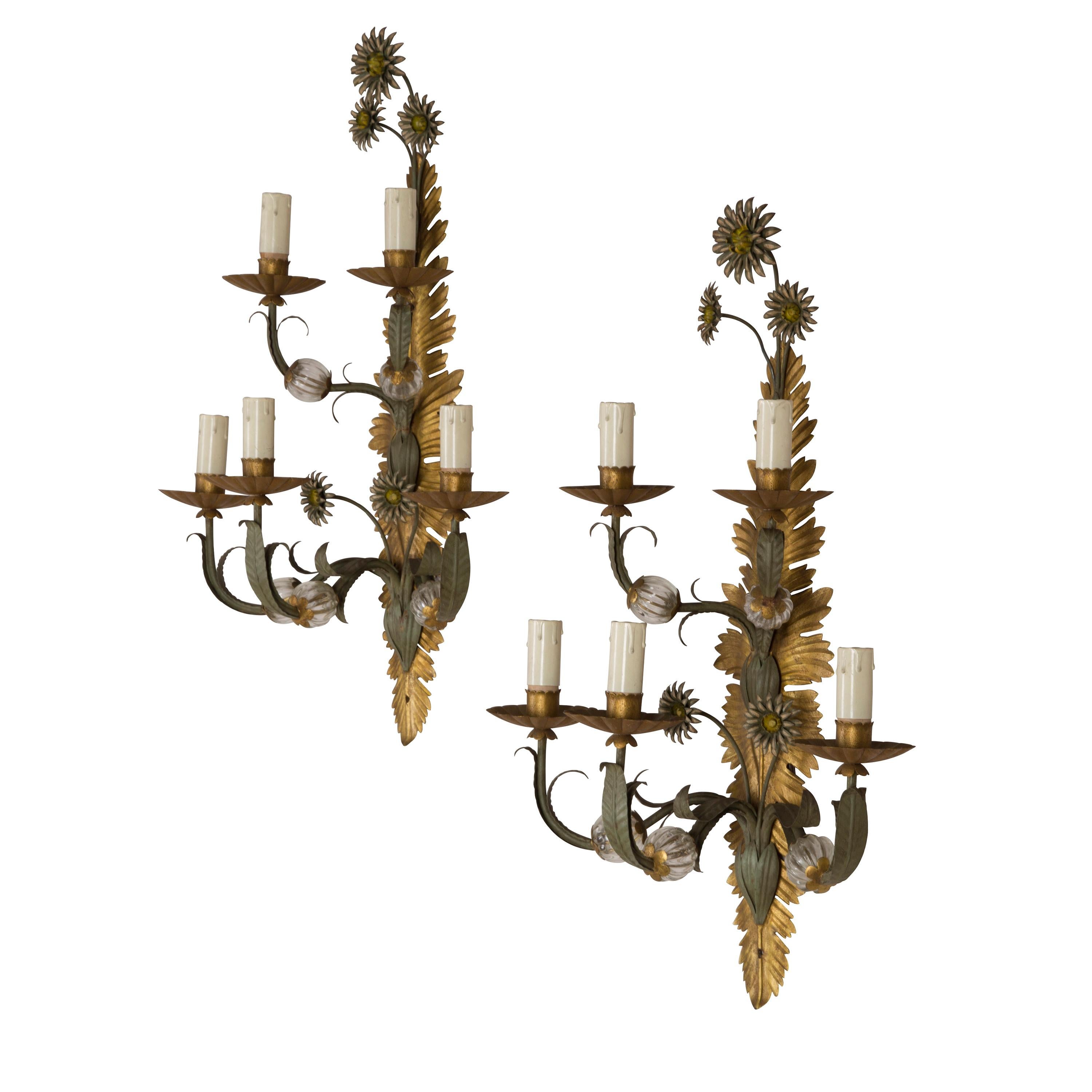 A very decorative pair of Italian, 1970s painted iron and glass 5-branch wall sconces.