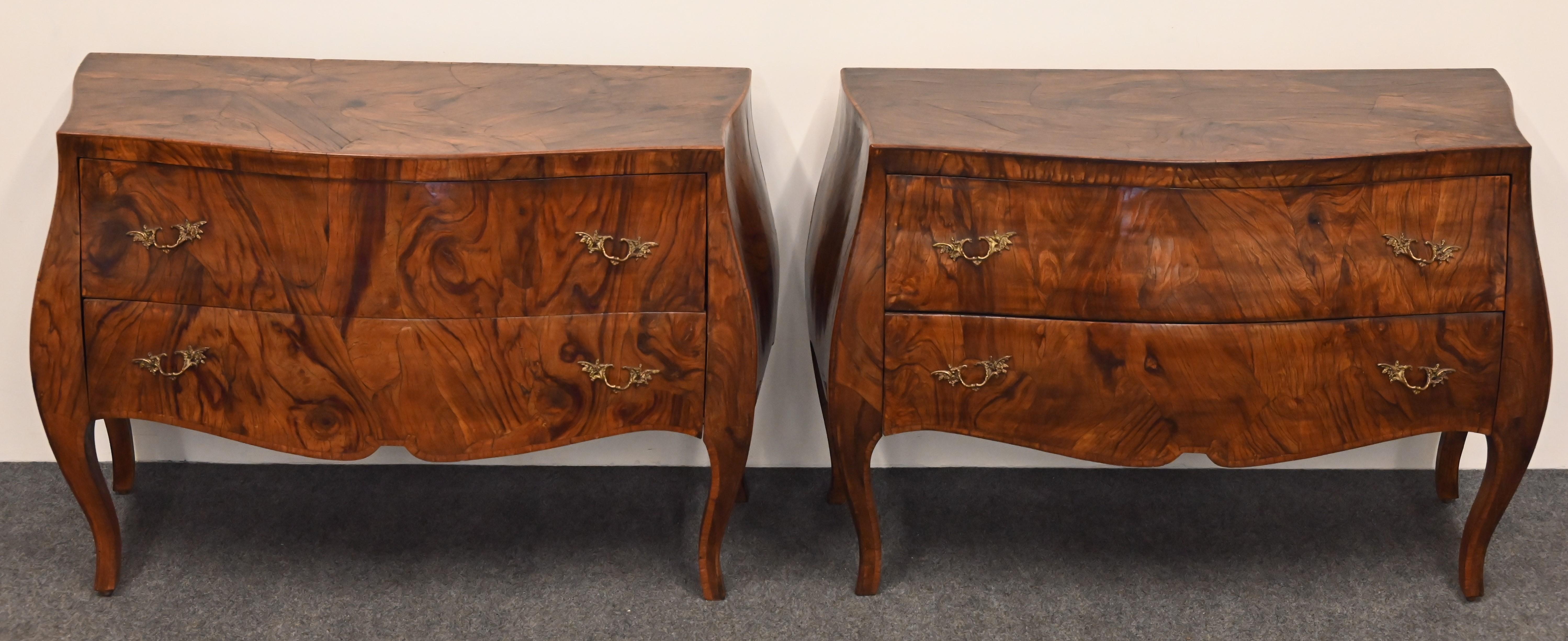 A gorgeous pair of Italian Walnut Burlwood commodes or chests. This pair of chests could be used on either side of the bed as nightstands. The large-scale commodes would look great in any interior, whether French, Italian, or Bohemian style. Great