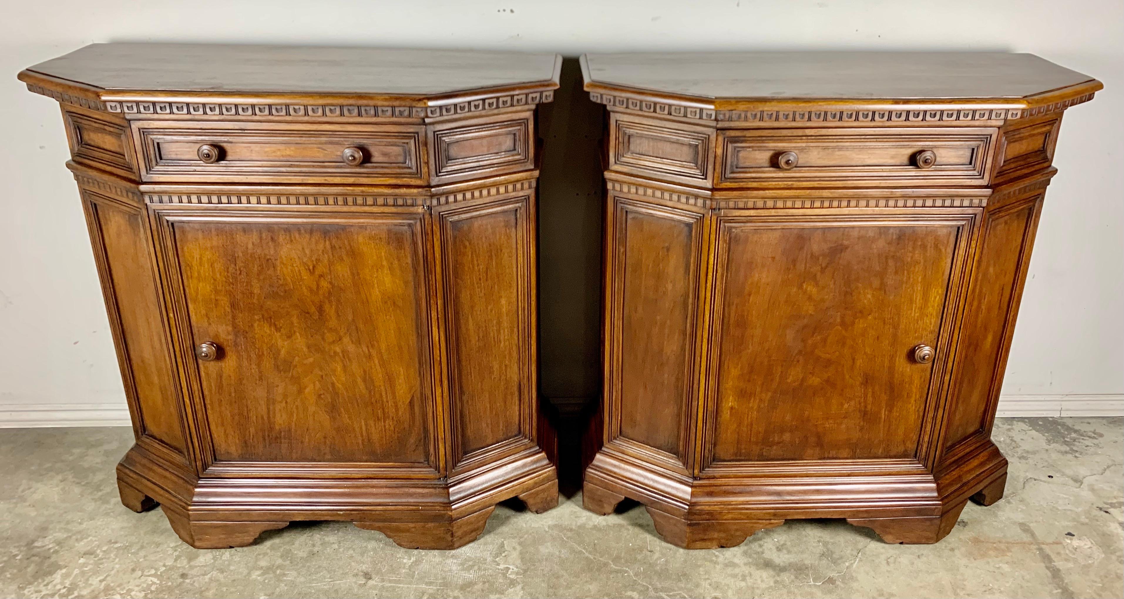 Pair of Italian walnut credenzas, circa 1930s. Beautiful carved details but simple and elegant in design. There is a single drawer and cabinet door on both pieces. One interior shelf is missing.