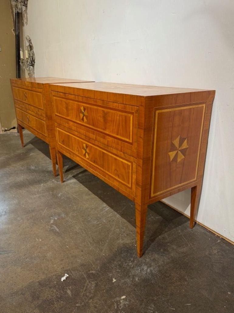 Good pair of Italian walnut Neo-classical star inlaid commodes. These commodes are ideal for adding architectural structure and historical charm to both traditional and modern interiors. Italian walnut Neo-Classical commodes with star inlay are