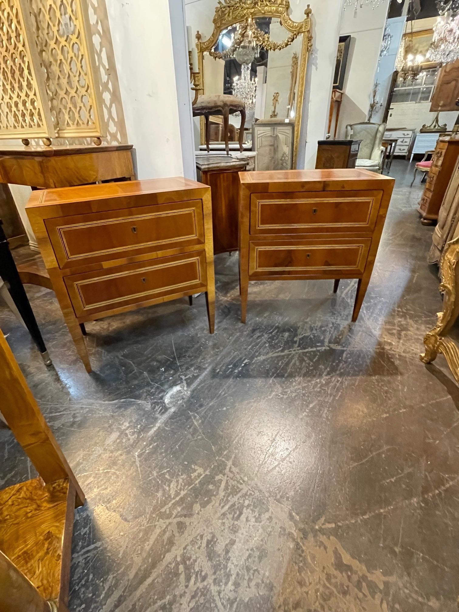 Lovely pair of Italian walnut Neo-Classical style bed side tables. These have a beautiful polished finish and a nice inlaid pattern as well. Very fine quality!