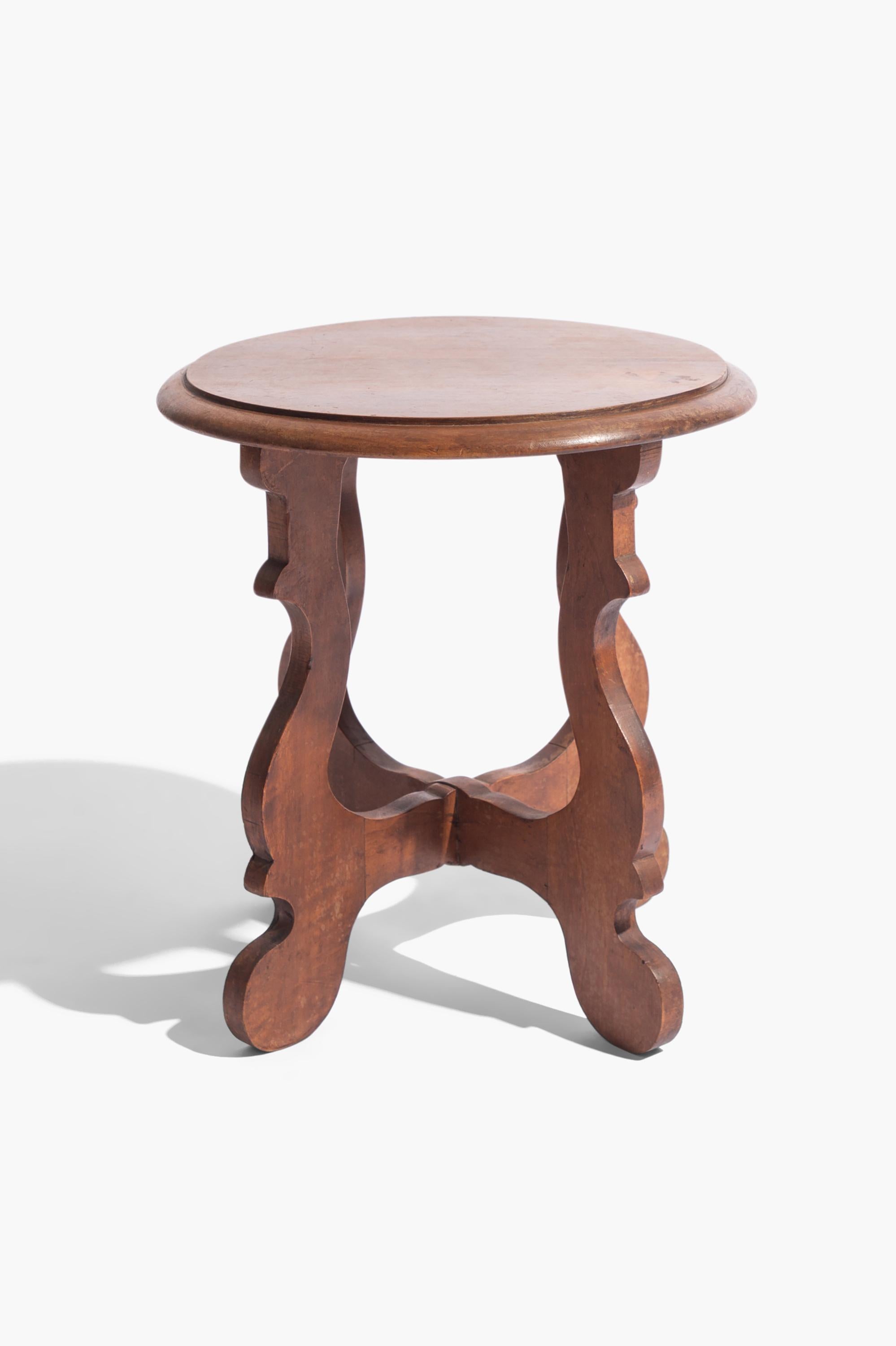 A pair of early 20th Century Italian side tables or low stools made in Walnut.

The cross section lyre shaped legs made in the style of an 18th Century 'Fratino' table. A similar design for a low side table can be found in the collection of Villa