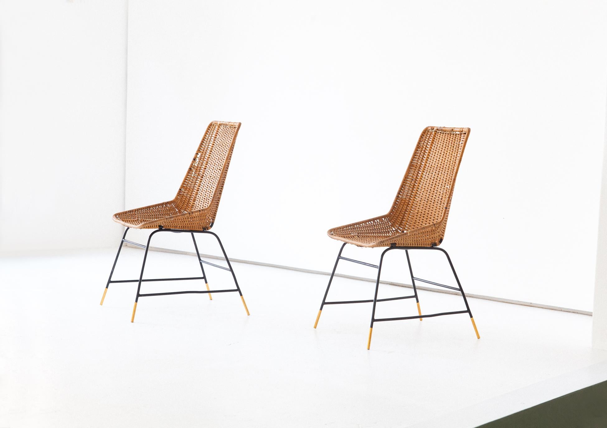 Set of two Mid-Century Modern easy chairs manufactured in Italy in the 1950s
This seat of each chair are made of wicker with black enameled iron frame and brass feats
Each frame of chair is restored but the wicker have signs of age and little