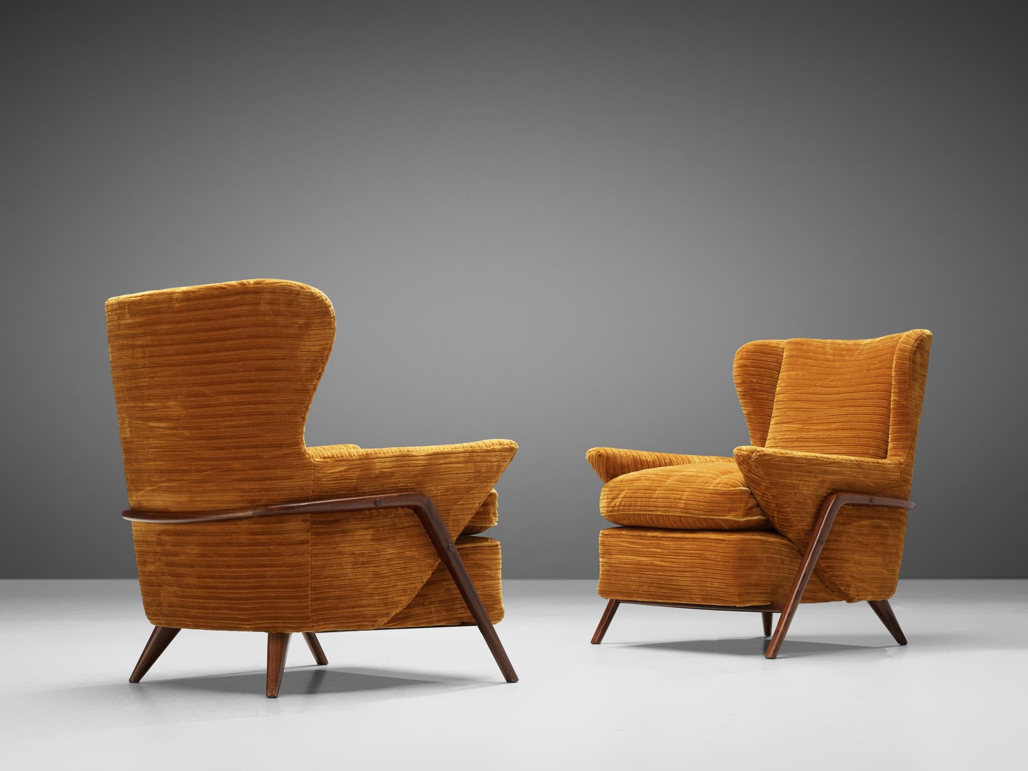 Pair of armchairs, textured ochre yellow upholstery, Italy, 1960s.

Pair of Italian wingback armchairs in textured ochre yellow upholstery. Remarkable about this pair of armchairs is their extravagant shape. The high backrest is joined by