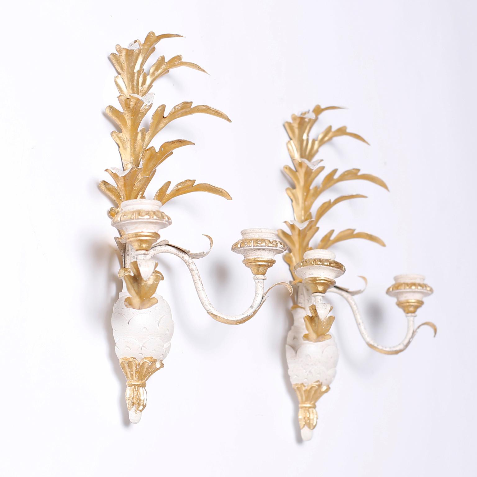 Pair of two light vintage Italian wall sconces with gilt metal acanthus leaves over two graceful painted arms with gilt highlights over painted stylized pineapples.