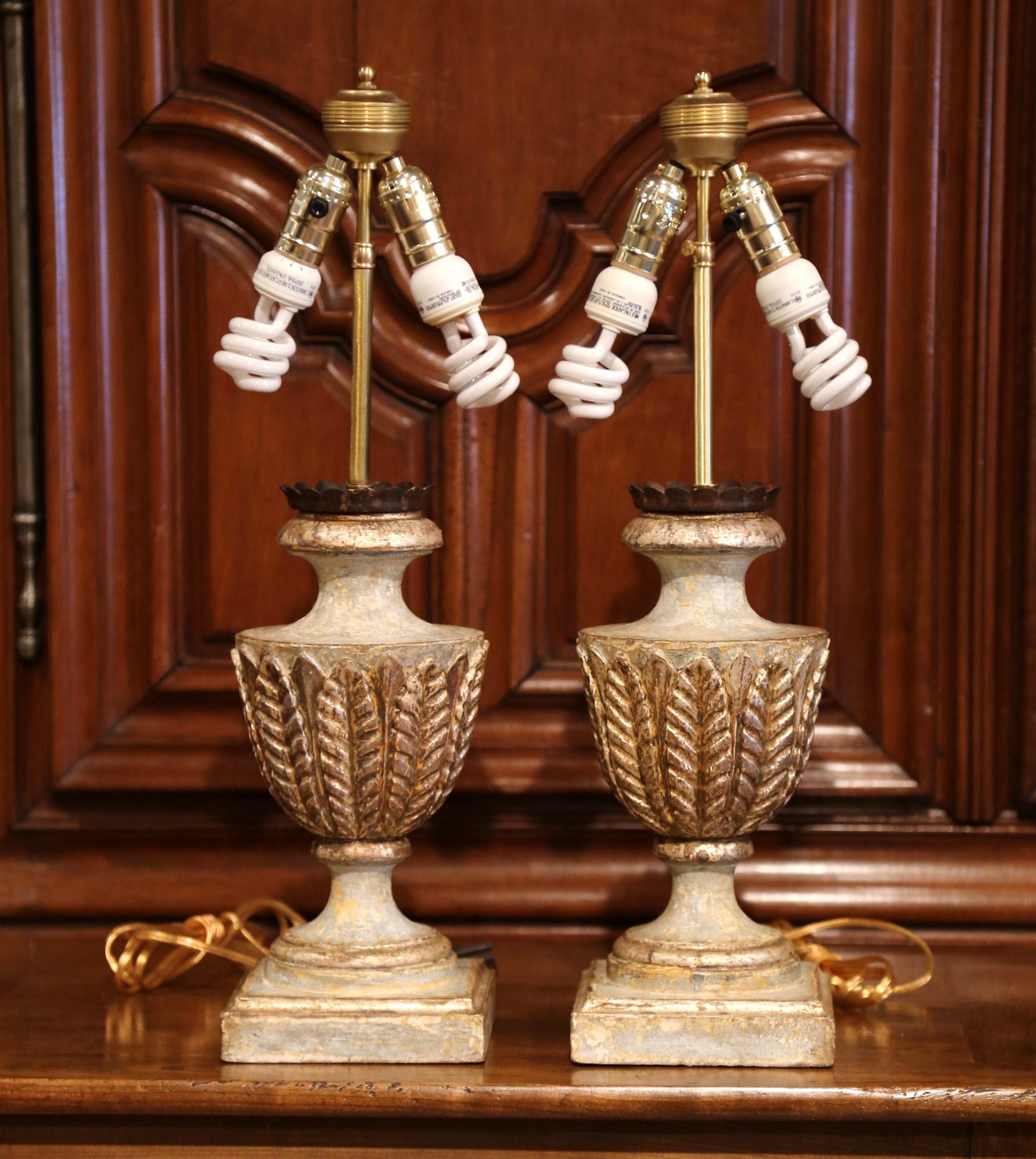 Incorporate extra light into a living room or bedroom with this elegant pair of hand-carved and hand-painted wood lamp bases from Italy. The large, stately bases are in the shape of a traditional antique urn and are embellished with carved acanthus