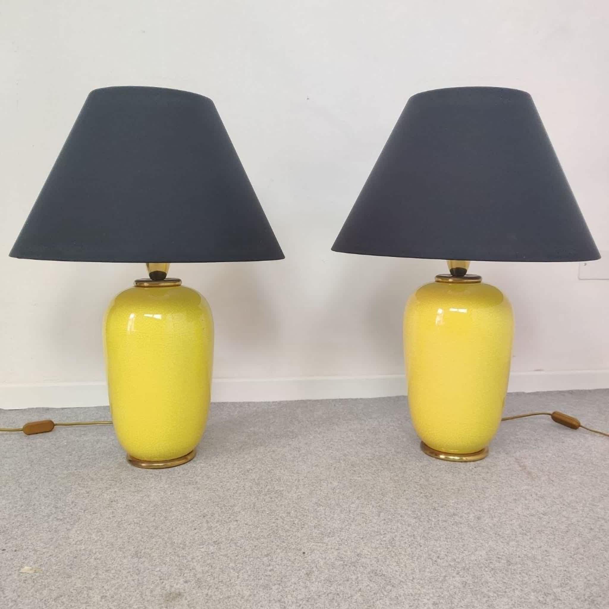 Elegante paire de grandes lampes de table italiennes produites par PAF Milano à la fin des années 1970.
Chaque lampe est composée d'un corps en céramique finement travaillé, d'une glaçure jaune chaude avec un subtil effet craquelé, reposant sur un