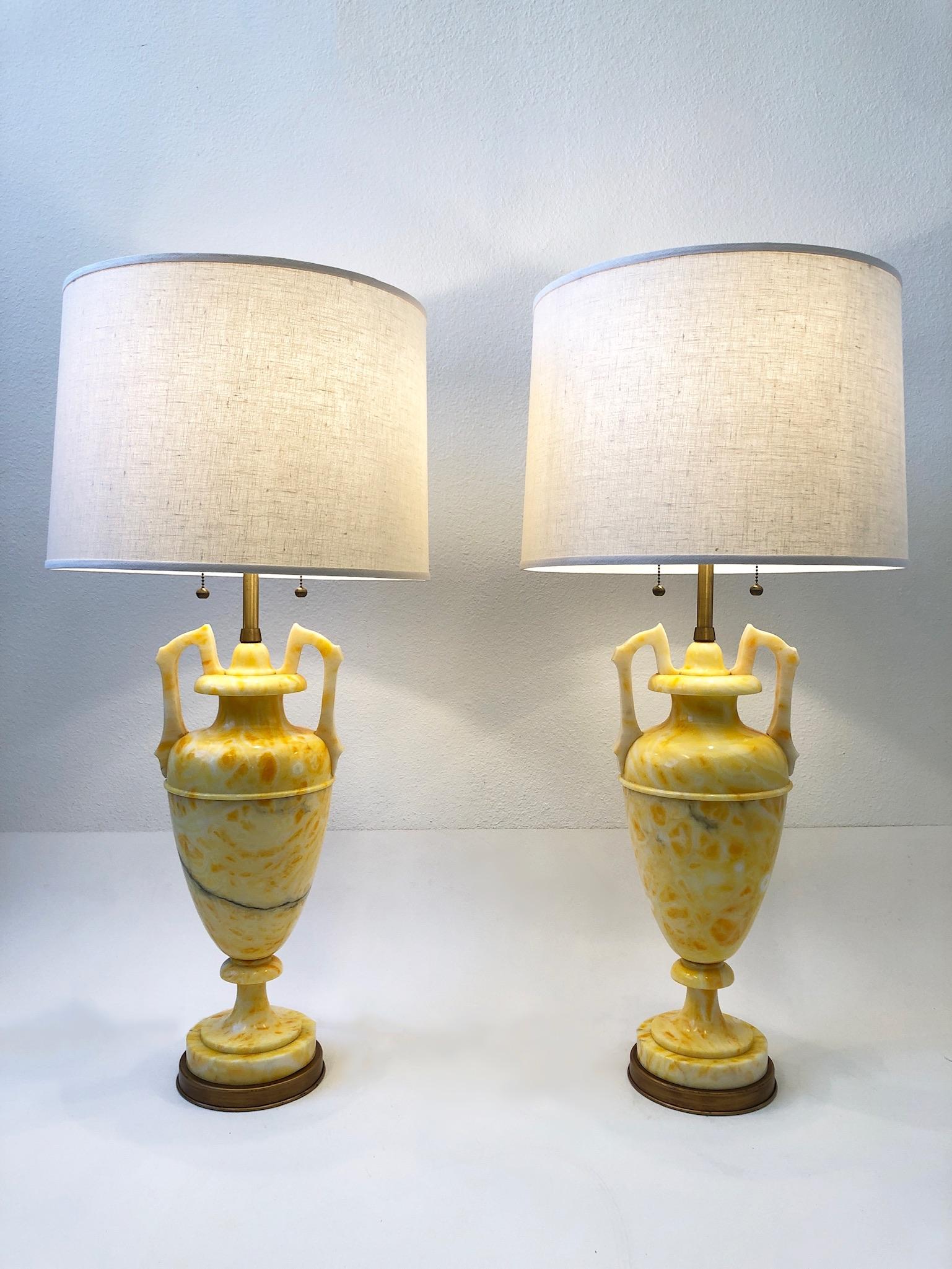 Spectacular pair of Italian yellow marble and satin brass table lamps by Marbro Lamp Co. 
Vibrant yellow color. Newly rewired and new vanilla linen shades. 
Measurements: 38” High and 18” Diameter.