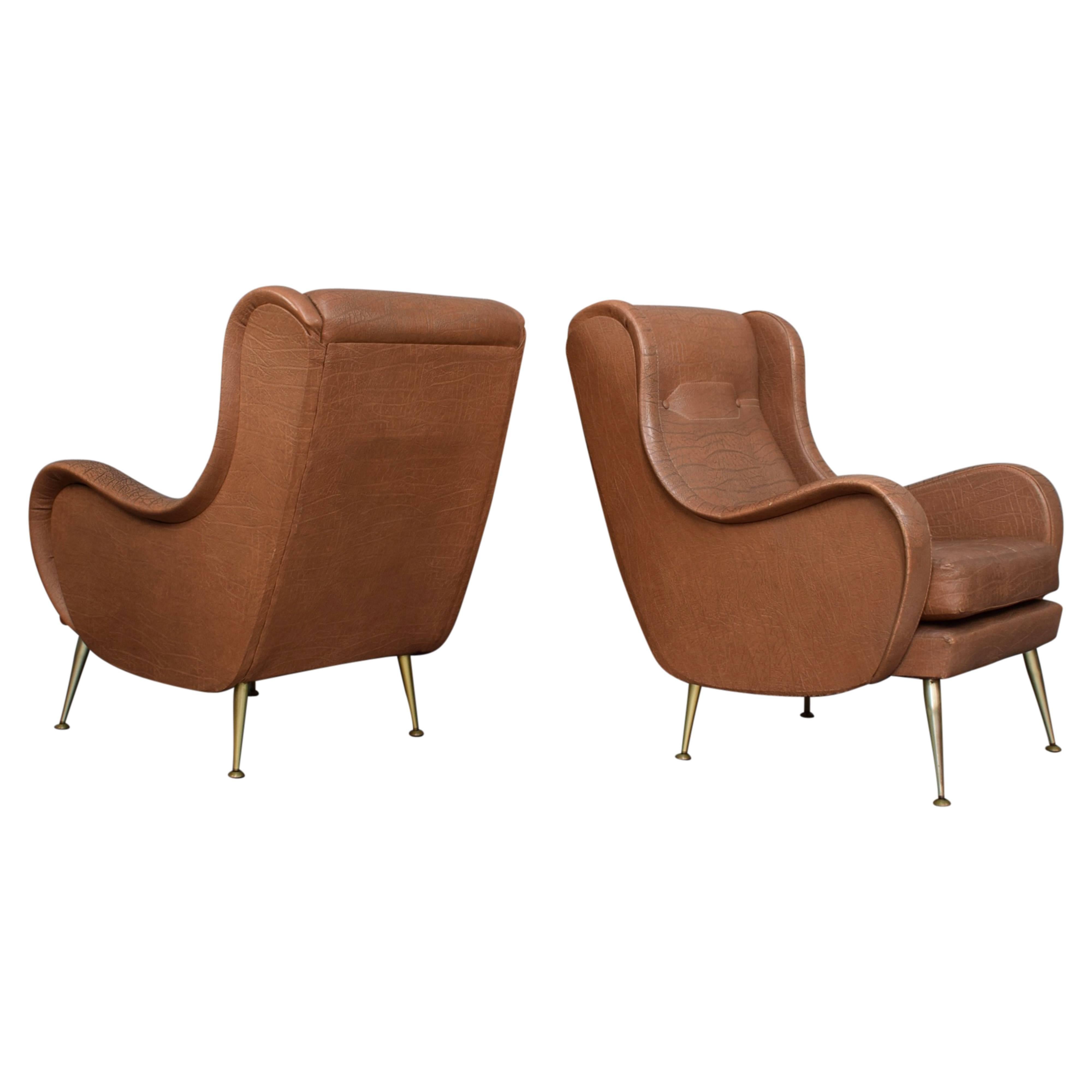 Gorgeous pair of Italian midcentury lounge chairs that will look best with a beautiful new fabric.

Design: Aldo Morbelli
Manufacturer: Unknown
Country: Italy
Model: Lounge wingback armchair
Material: Faux leather
Designed in 1950s
Date of