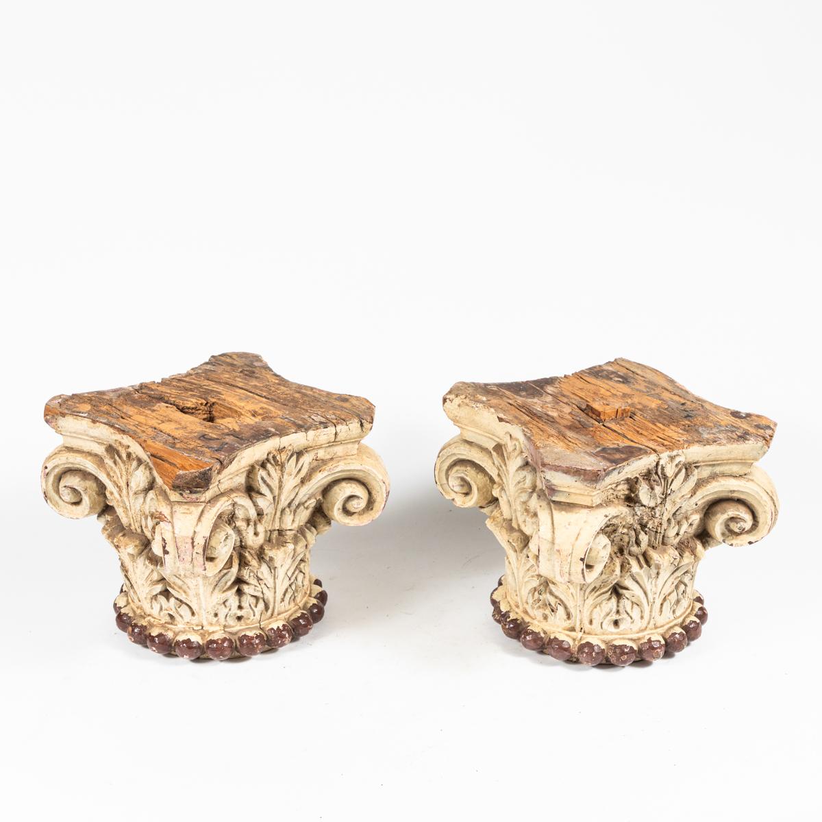 Pair of early 19th-century Italian ivory painted wood capitals. Originally used to frame a set of composite-style columns, these beautiful architectural elements would be great as sculptures. With a beautifully aged patina and attenuated floral